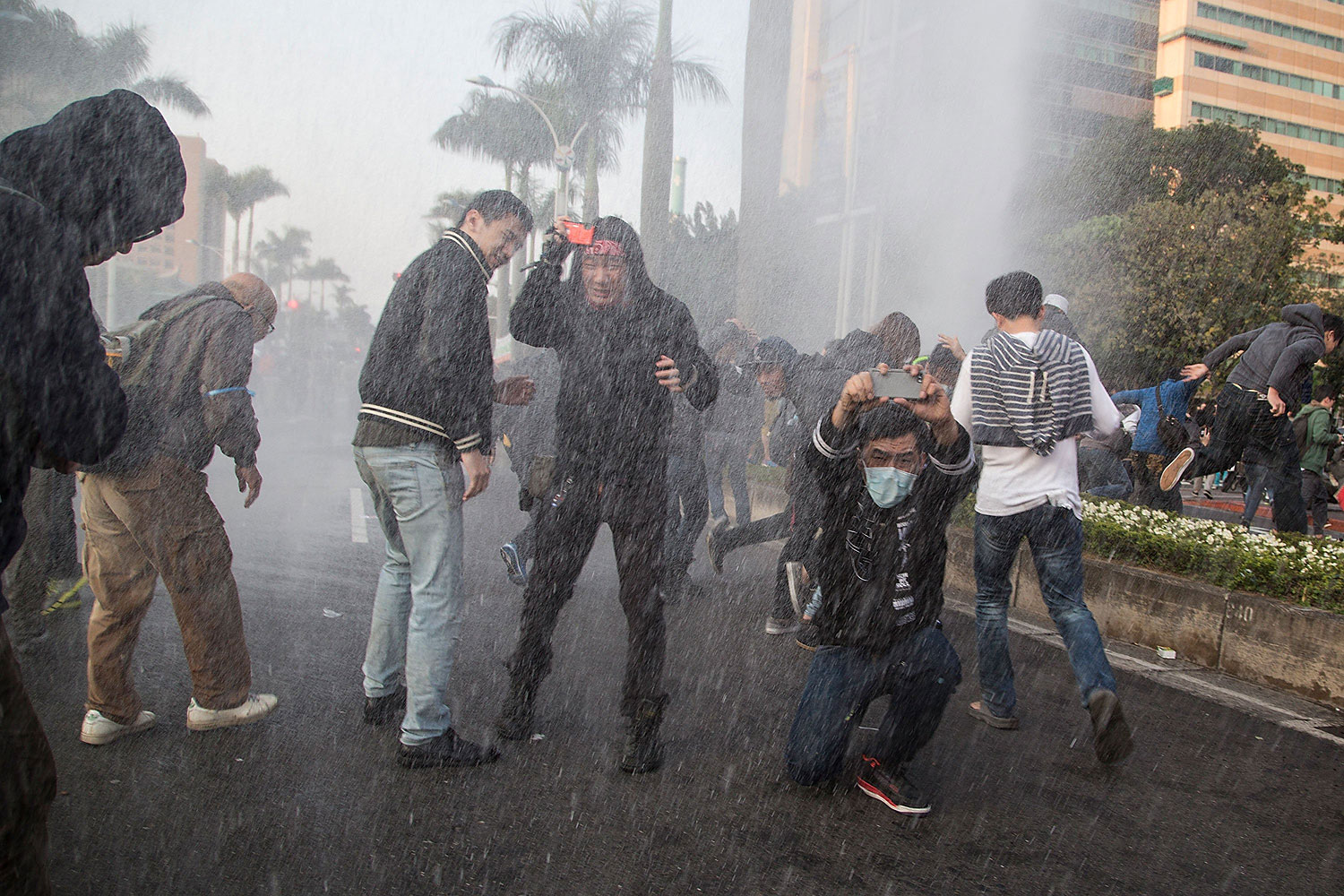 Riot police use water cannons during a clash with student protesters outside the Executive Yuan, a branch of government in charge of administrative affairs for all of Taiwan on March 24, 2014 in Taipei, Taiwan.