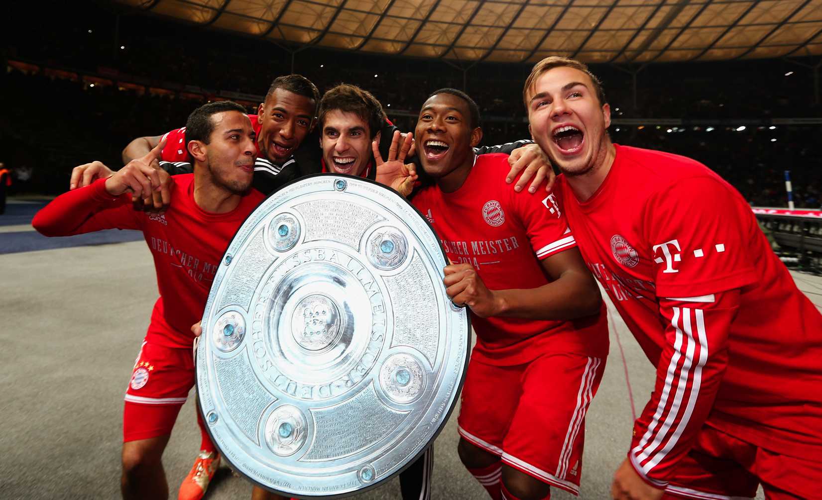 Thiago Alcantara, Jerome Boateng, Javier Martínez Aguinaga, David Alaba and Mario Goetze of Bayern Muenchen celebrate winning the German Championship after the Bundesliga match between Hertha BSC and FC Bayern Muenchen at Olympiastadion on March 25, 2014 in Berlin, Germany. (Boris Streubel—Bongarts / Getty Images)