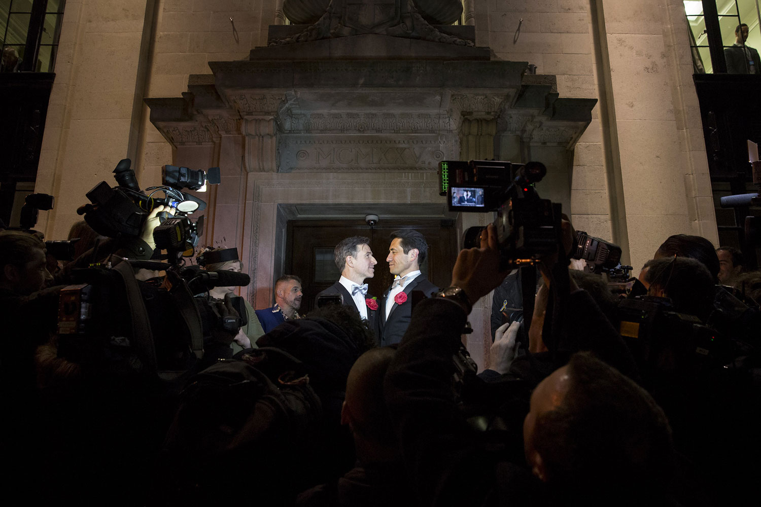 Gay couple Peter McGraith and David Cabreza stand on the steps of Islington Town Hall after being married shortly after midnight in one of the UK's first same-sex weddings on March 29, 2014 in London. (Rob Stothard—Getty Images)