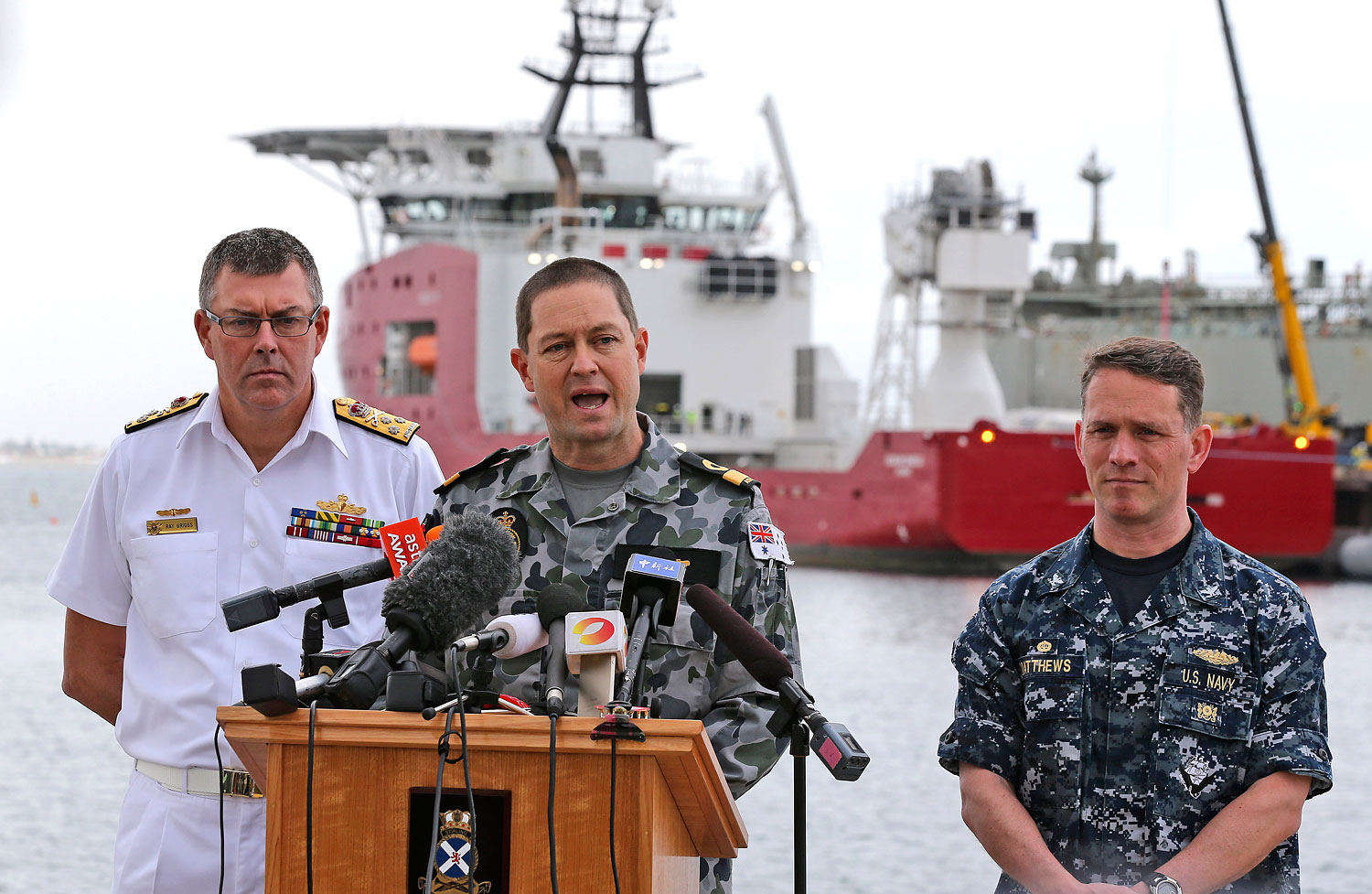 From right, U.S. Navy Captain Mark Matthews, Royal Australian Navy Commodore Peter Leavy and chief of the navy Vice Admiral Ray Griggs speak at a press conference at naval base HMAS Stirling about the search for missing Malaysia Airlines Flight 370 in Perth, Australia, on March 30, 2014 (Rob Griffith—AP)