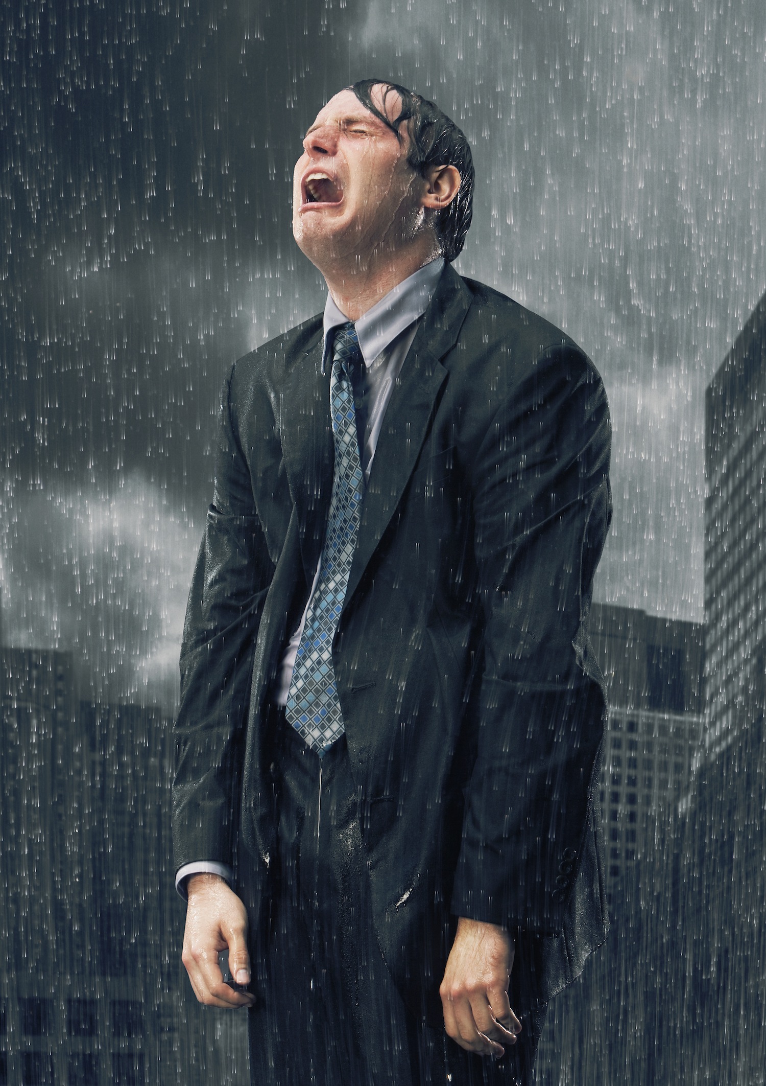 Businessman crying in rain