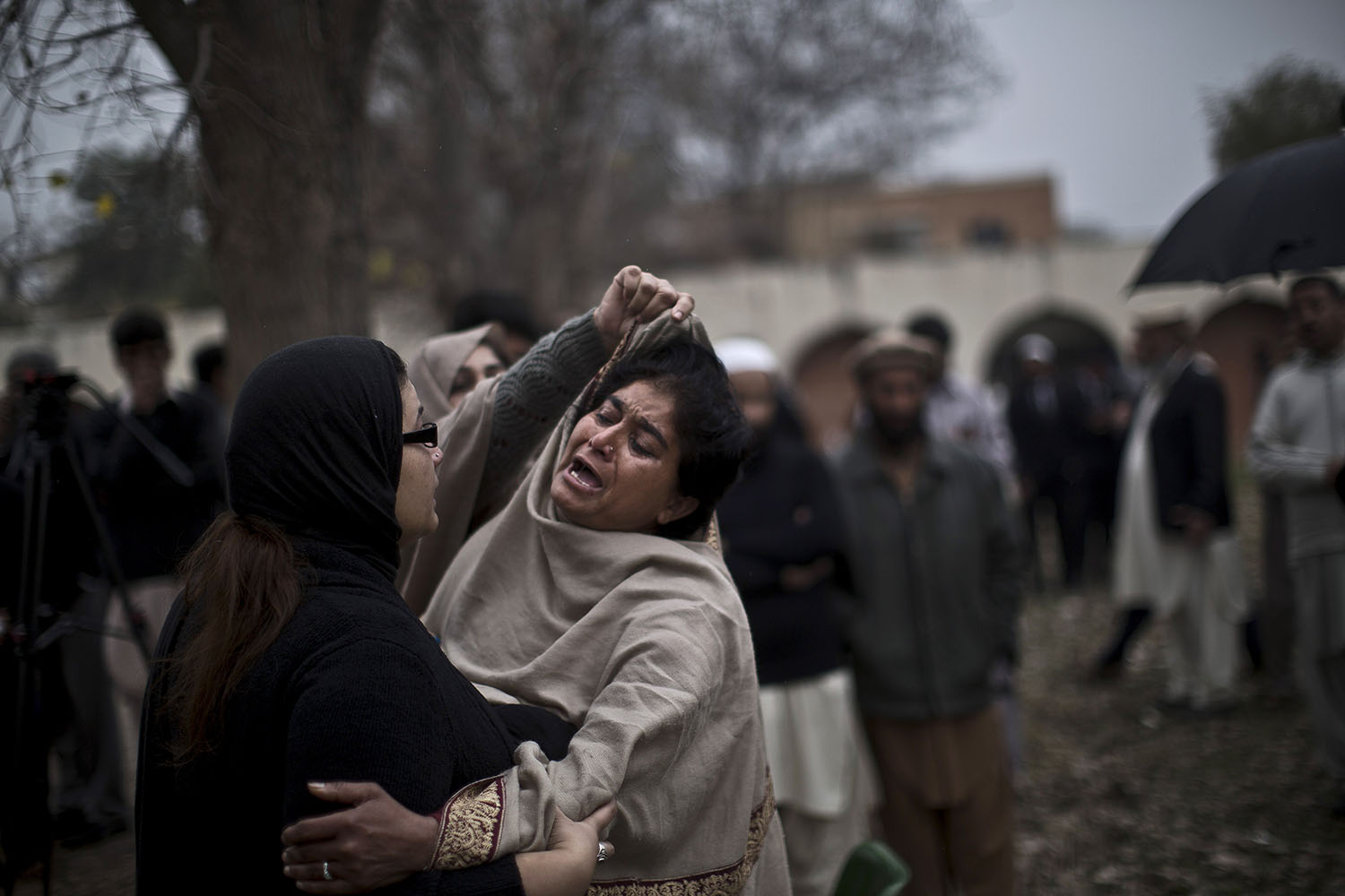 Mar. 3, 2014. A woman grieves outside a hospital's morgue for victims of a twin suicide bombing in Islamabad, Pakistan.