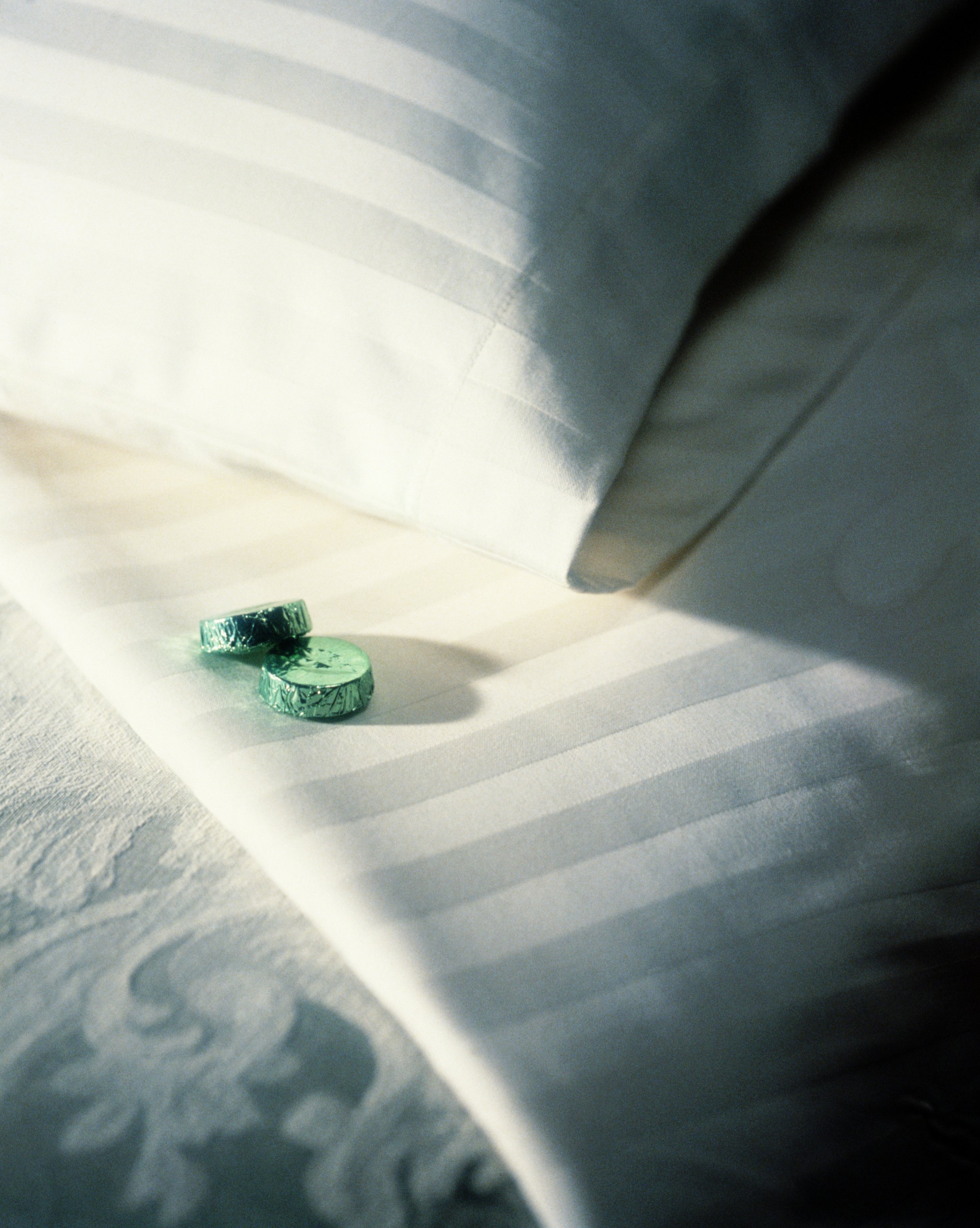 Two mints on hotel bed
