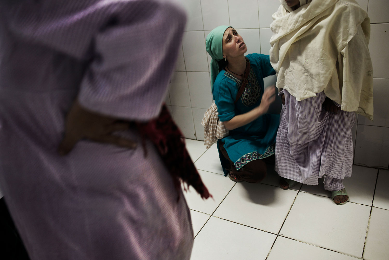 In Kabul, women going through labor are helped by midwives at the Ahmed Shah Baba Hospital, which is known for its maternity care. Midwife Iline Ceelen comforts a woman going through labor who is around 13 years old.  The Ahmed Shah Baba Hospital sees, on average, 900 to 1000 births a month.