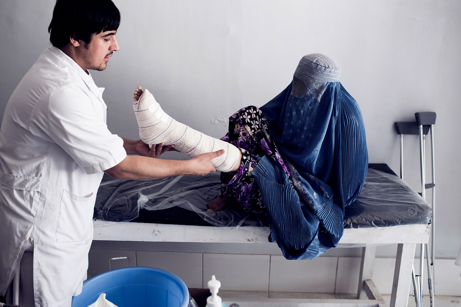 MSF doctor treats a female patient at the OPD of Kunduz Trauma Center in Kunduz, Northern Afghanistan.