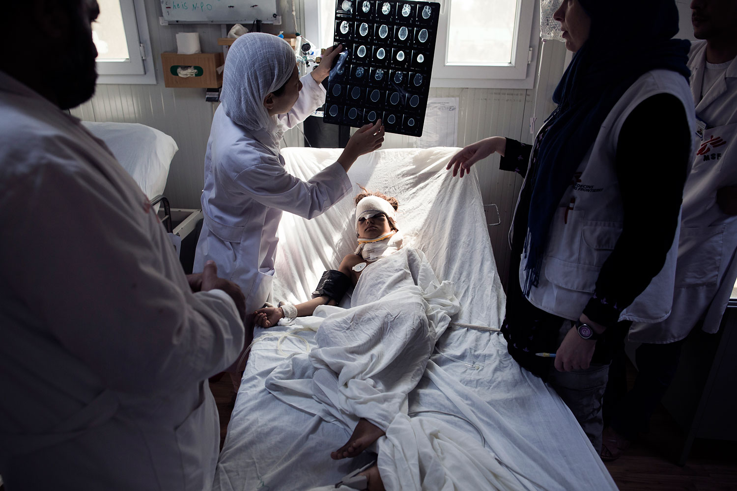 Doctors examine a head trauma patient at the ICU of Kunduz Trauma Center in Kunduz, Northern Afghanistan.