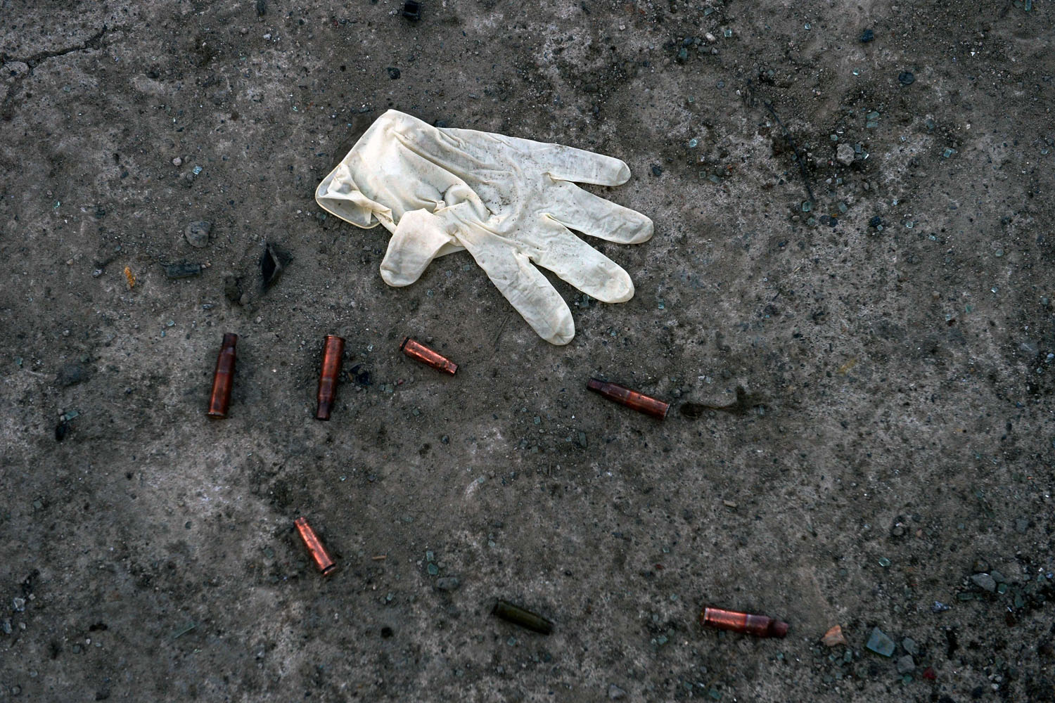 Mar. 25, 2014. A latex glove from an investigator lies on the floor near empty bullet casings at the site of a deadly attack on an Afghan election commission office in Kabul. Insurgents have vowed a campaign of violence to disrupt the ballot on April 5, urging their fighters to attack polling staff, voters and security forces in the run-up to election day.