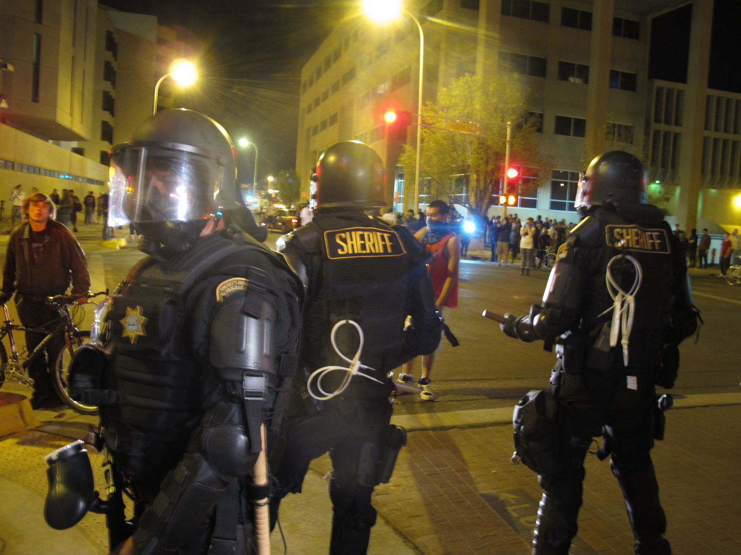 Riot police stand guard in front of protesters in downtown Albuquerque, N.M., Sunday, March 30,2014. (Russell Contreras - AP)