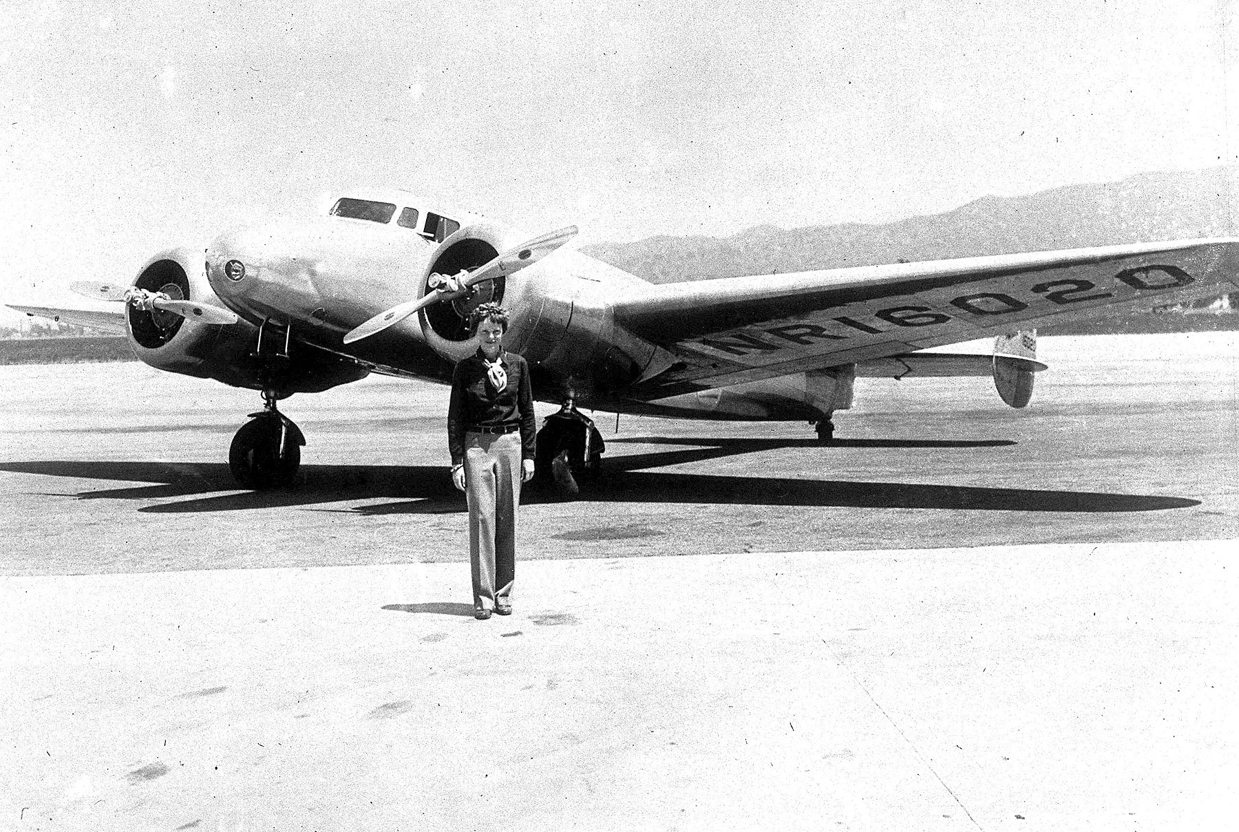 Amelia Earhart is pictured with her Flying Laboratory in which she attempted to fly around the world from Oakland, Ca.