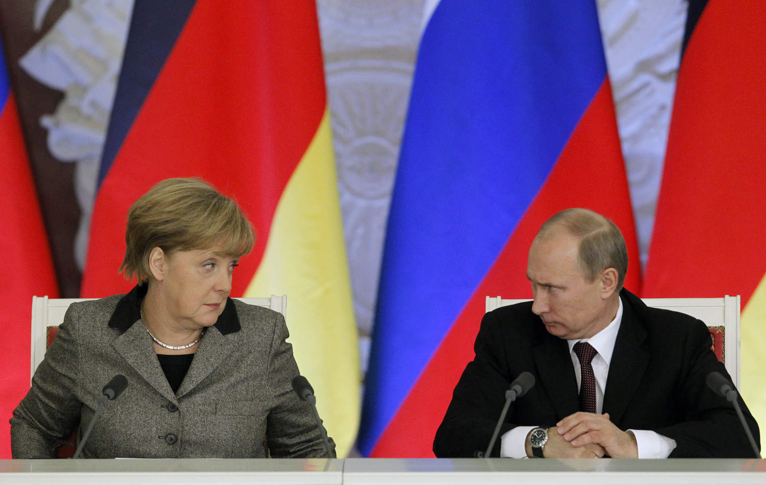 From left: German Chancellor Angela Merkel and Russian President Vladimir Putin answer journalists' questions during a joint news conference in Moscow's Kremlin Nov. 16, 2012. 
