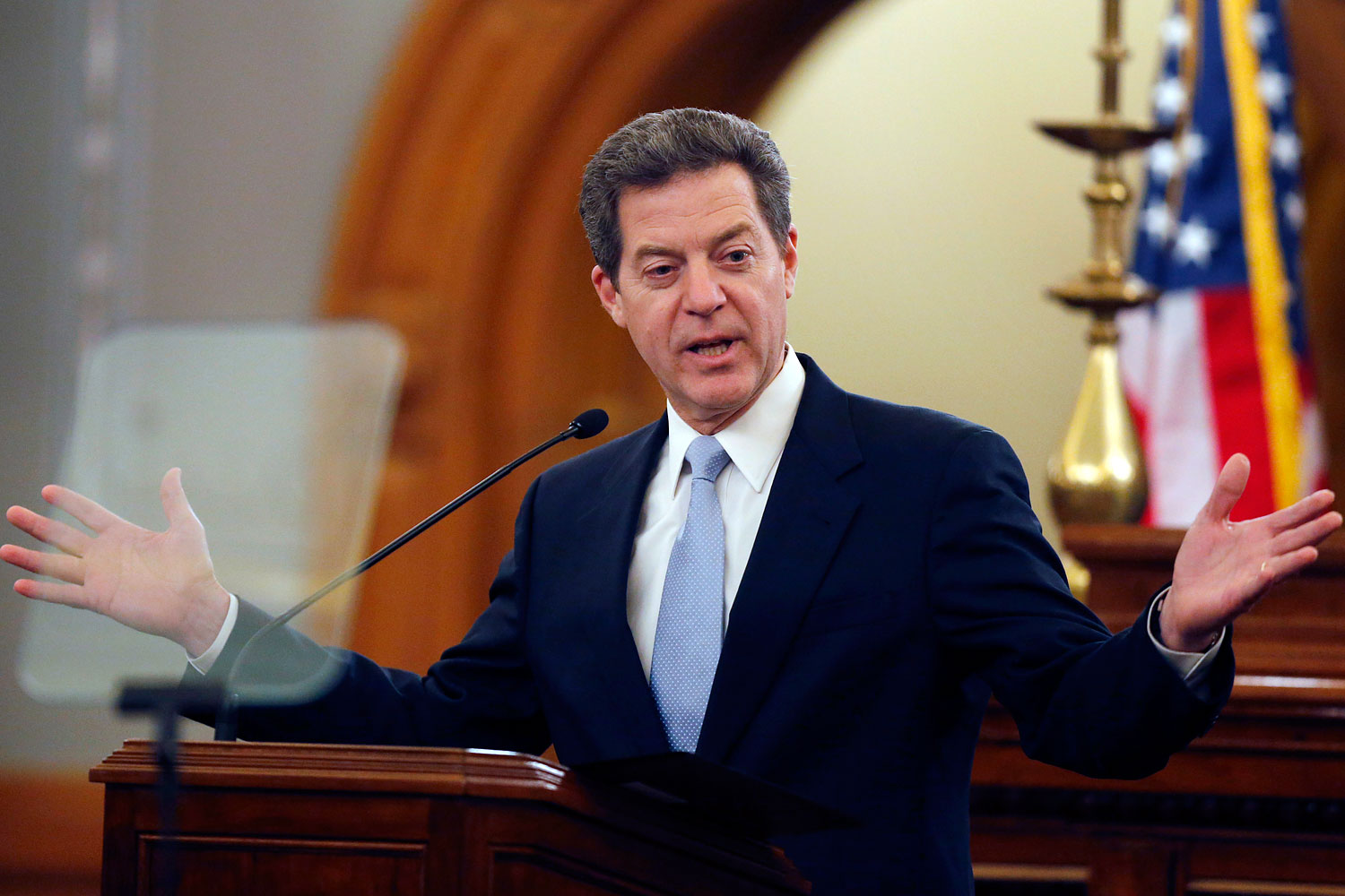 Kansas Gov. Sam Brownback delivers his State of the State speech to an annual joint session of the state House and Senate at the Statehouse in Topeka, Kan., Jan. 15, 2014. (Orlin Wagner—AP)