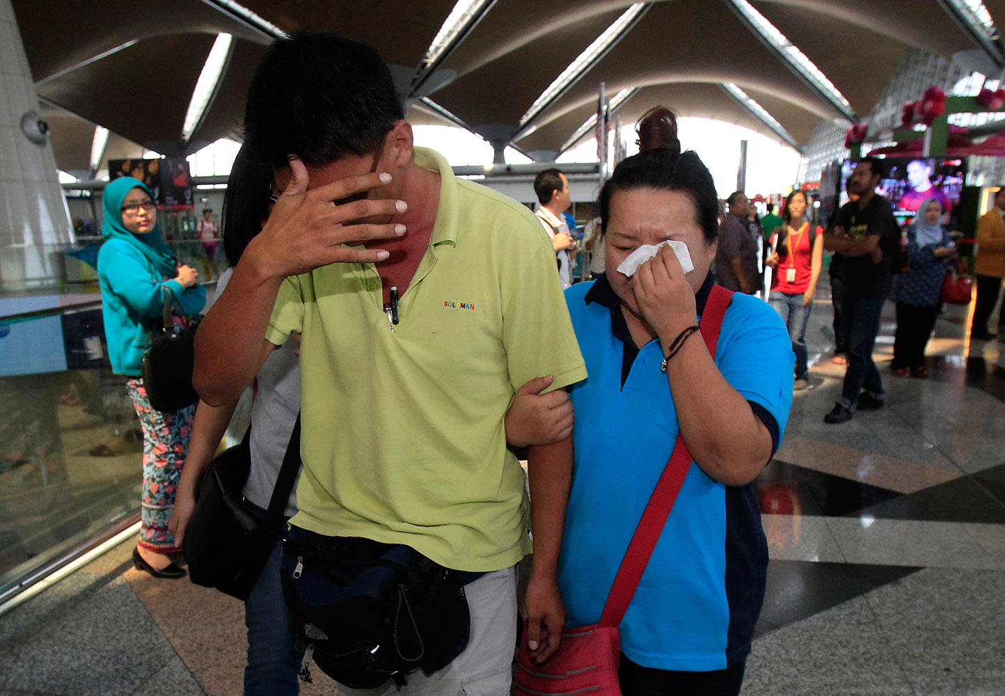 A woman wipes her tears after walking out from the reception center and holding area for family and friends of passengers aboard the missing plane, at Kuala Lumpur International Airport in Sepang, outside Kuala Lumpur, Malaysia, March 8, 2014. (Lai Seng Sin—AP)