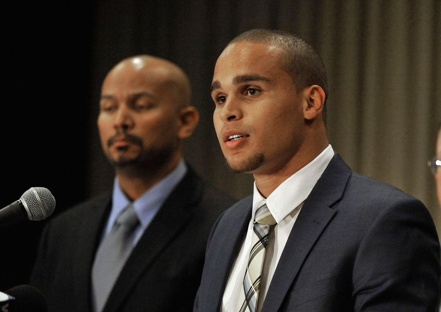 Northwestern quarterback Kain Colter, right, speaks while College Athletes Players Association President Ramogi Huma listens during a news conference in Chicago, Jan. 28, 2014. (Paul Beaty—AP)