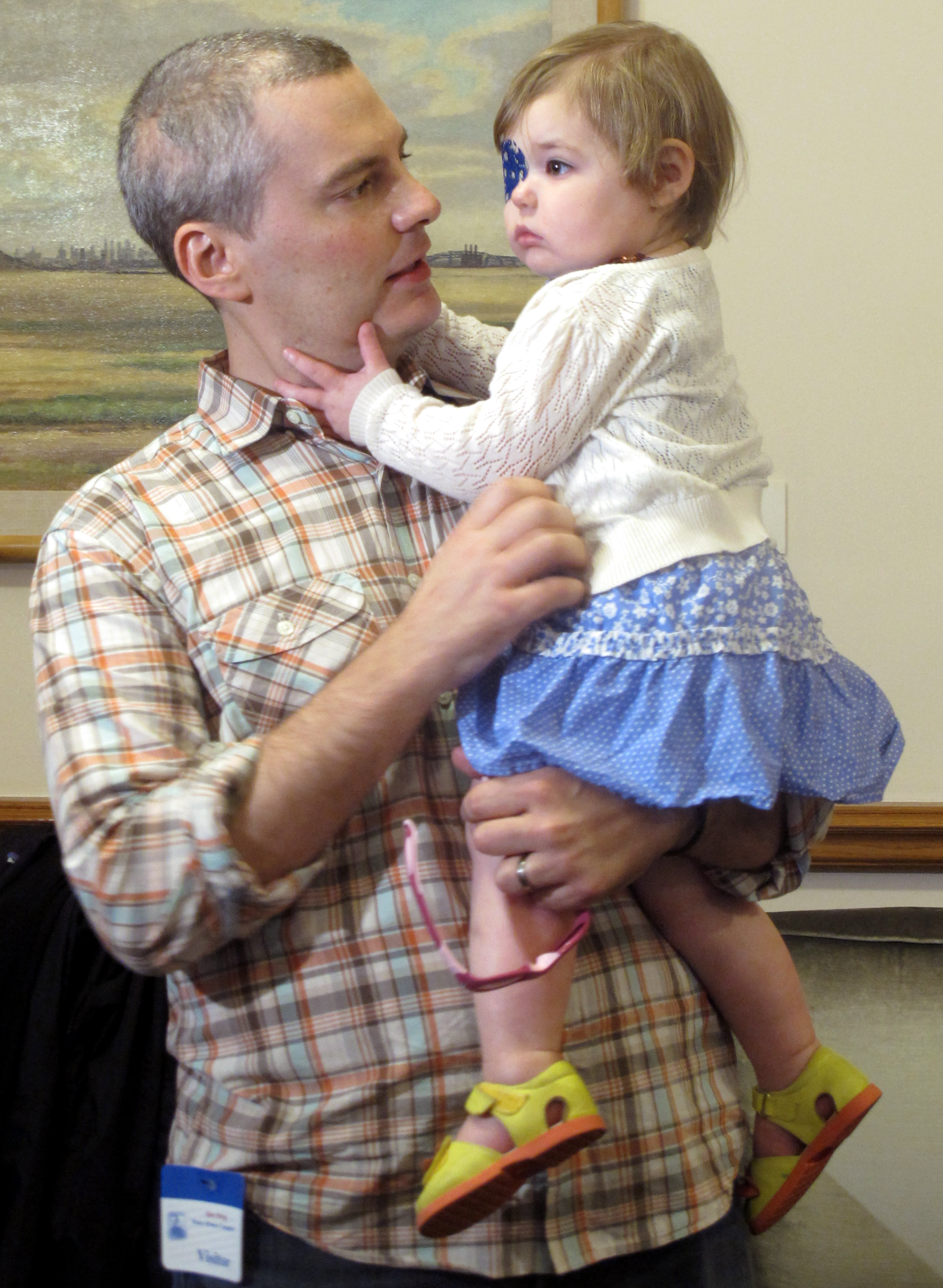 Brian Wilson, of Scotch Plains, N.J. holds his 2-year-old daughter Vivian. (Geoff Mulvihill—AP)