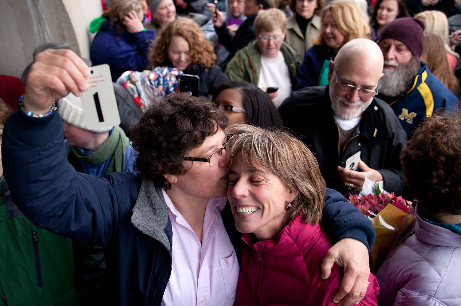 Elizabeth Patten, left, holds up the first marriage ticket to marry her partner Johnnie Terry in front of the Washtenaw County Clerks office in Ann Arbor, Mich., March 22, 2014, prior to the postponement of same-sex marriages by a federal appeals court. (Patrick Record—AP)
