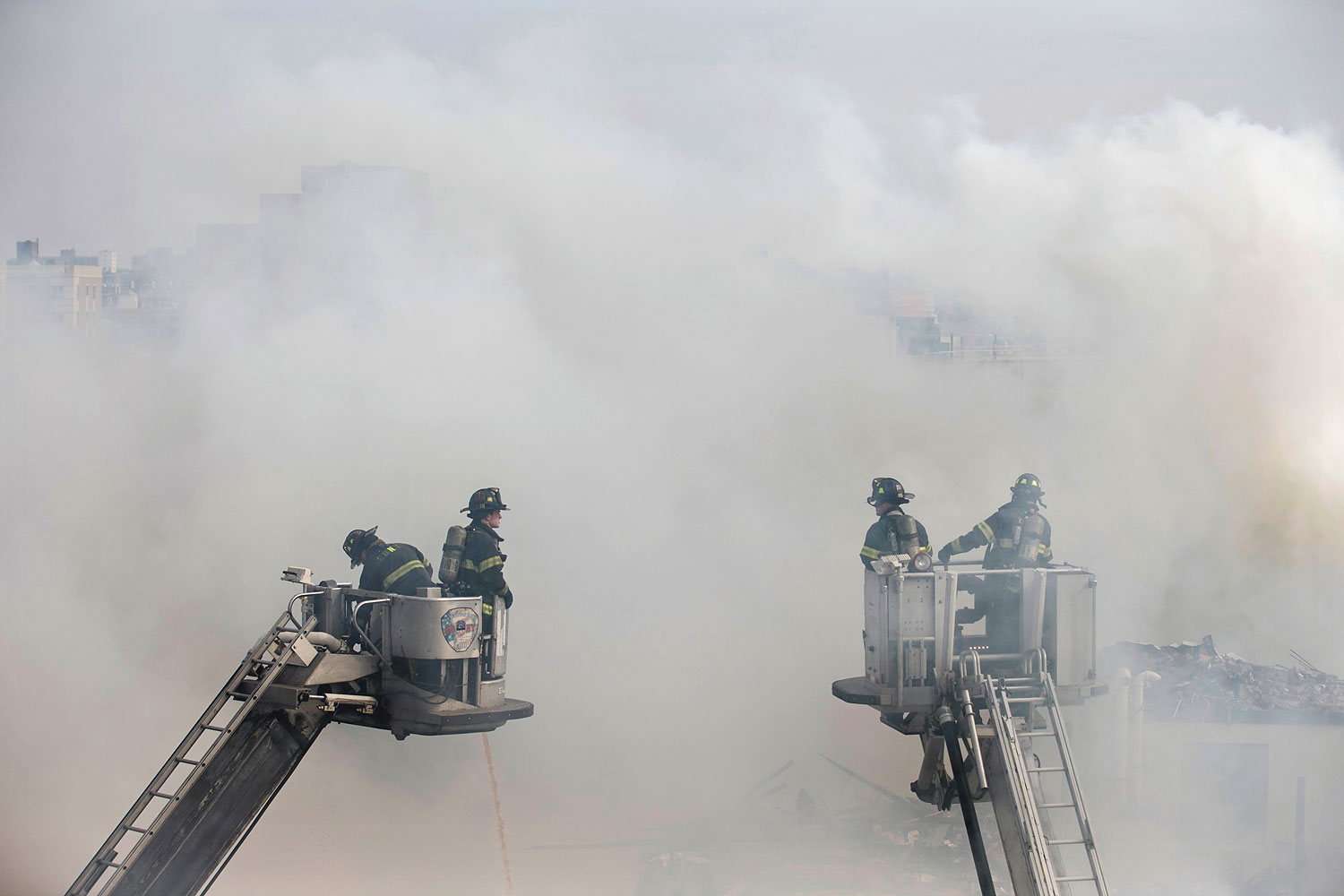 Firefighters respond to an explosion that leveled two apartment buildings in the East Harlem neighborhood of New York, March 12, 2014.