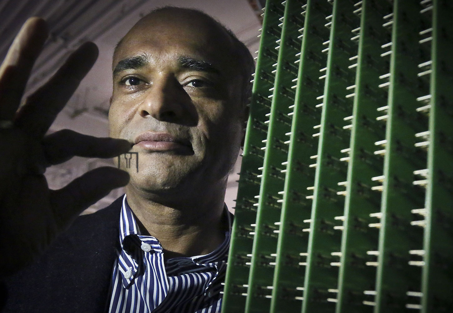 Chet Kanojia, founder and CEO of Aereo, Inc., stands next to a server array of antennas in New York, Dec. 20, 2012.