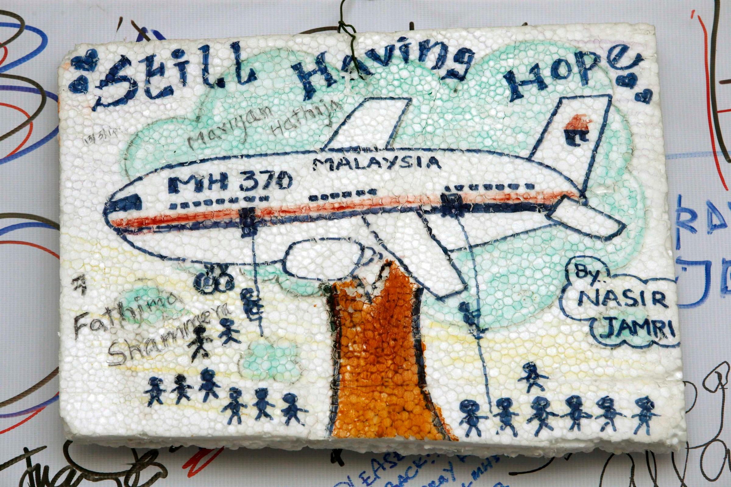 An artwork conveying well-wishes for the missing Malaysia Airlines Flight MH370 is seen in Kuala Lumpur International Airport