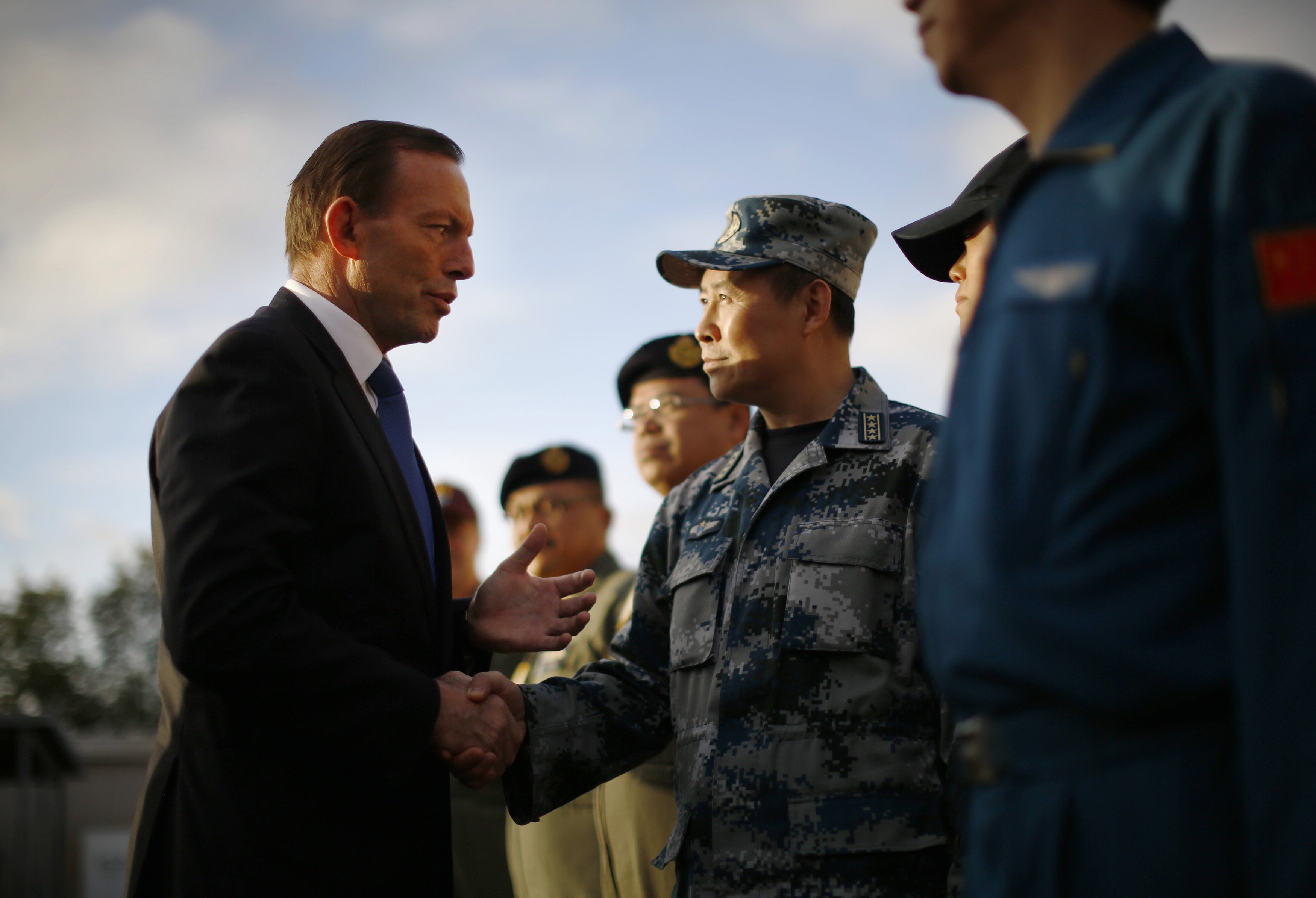 Australian Prime Minister Tony Abbott speaks with China's Air Force Senior Colonel Liu Dian Jun, head of China's effort to locate Malaysia Airlines flight MH370, during his visit to RAAF Base Pearce on March 31, 2014 in Perth, Australia. (Jason Reed—Getty Images)