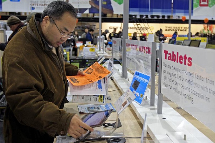 A shopper looks at tablet computers at a Best Buy Store on the shopping day dubbed "Black Friday" in Framingham