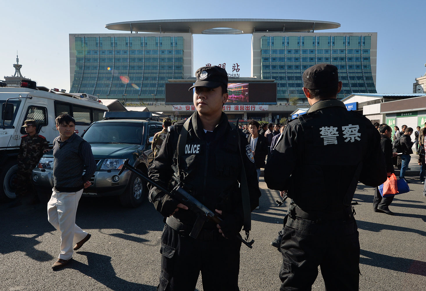 Chinese paramilitary police stand guard outside the scene of the terror attack at the main train station in Kunming, Yunnan Province, on March 3, 2014.