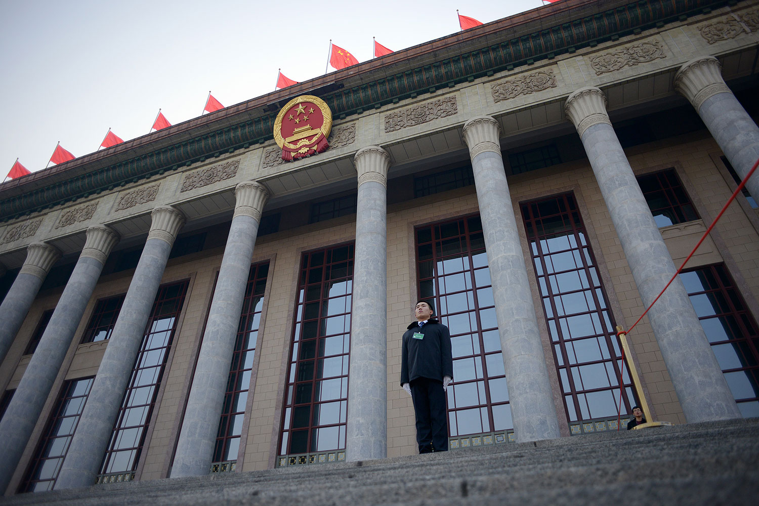 A security guard stands in front of The Great Hall of the People before the upcoming opening sessions of the National People's Congress (NPC) in Beijing on Mar. 2, 2014 (Wang Zhao / AFP / Getty Images)