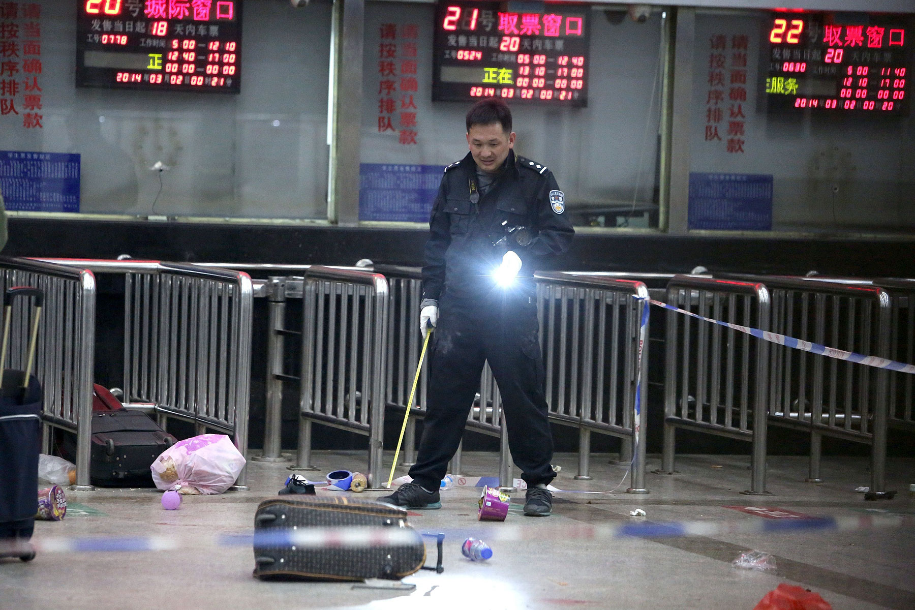 A Chinese police investigator in Kunming’s railway station after the March 1 mass knifings that killed 29 people and injured scores (AFP / Getty Images)