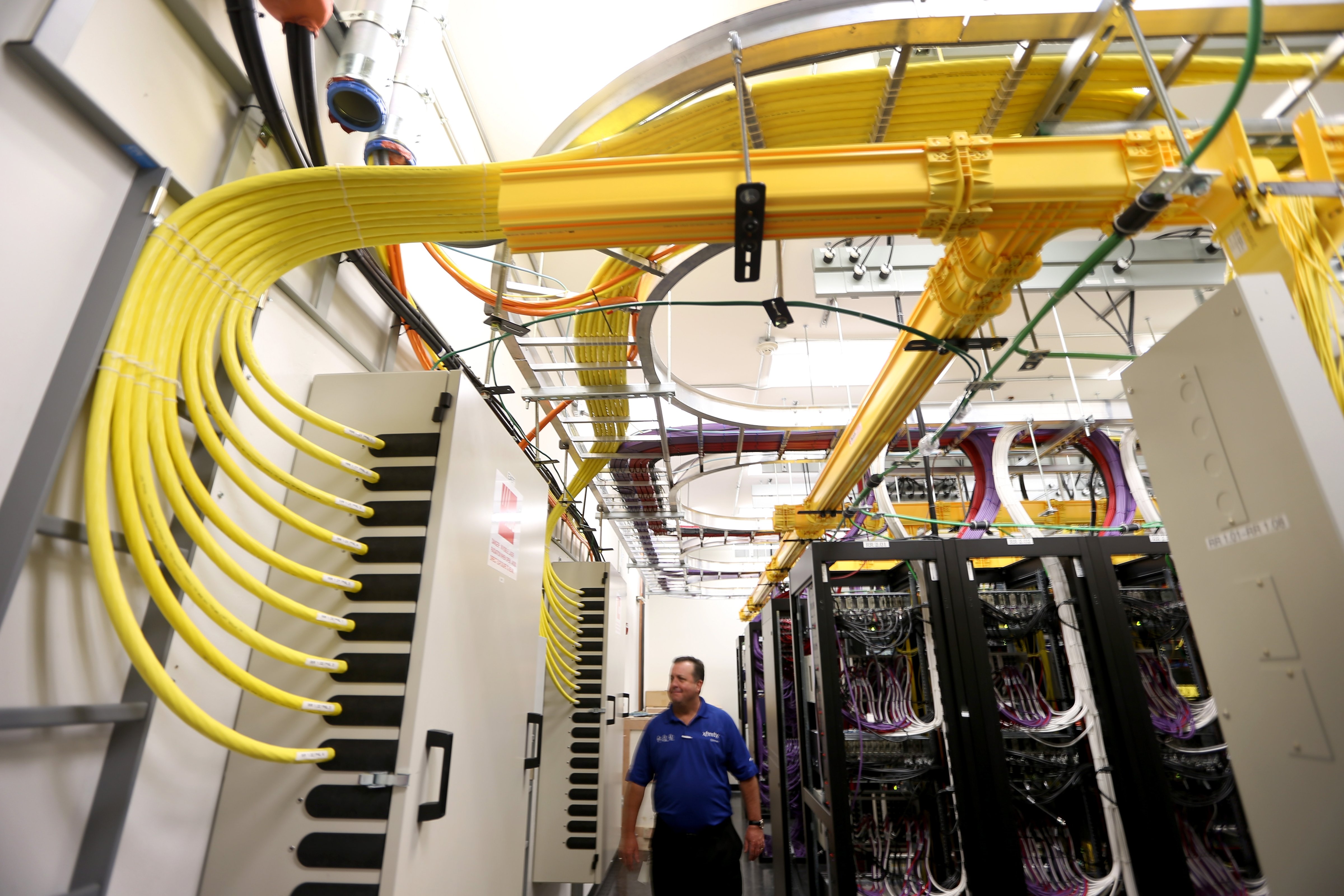 Brian Hunt,  Director Engineering, South Florida, stands among the cables and routers at a Comcast distribution center where the Comcast regional video, high speed data and voice are piped out to customers on February 13, 2014 in Miramar, Fla. (Joe Raedle&amp;mdash;Getty Images)