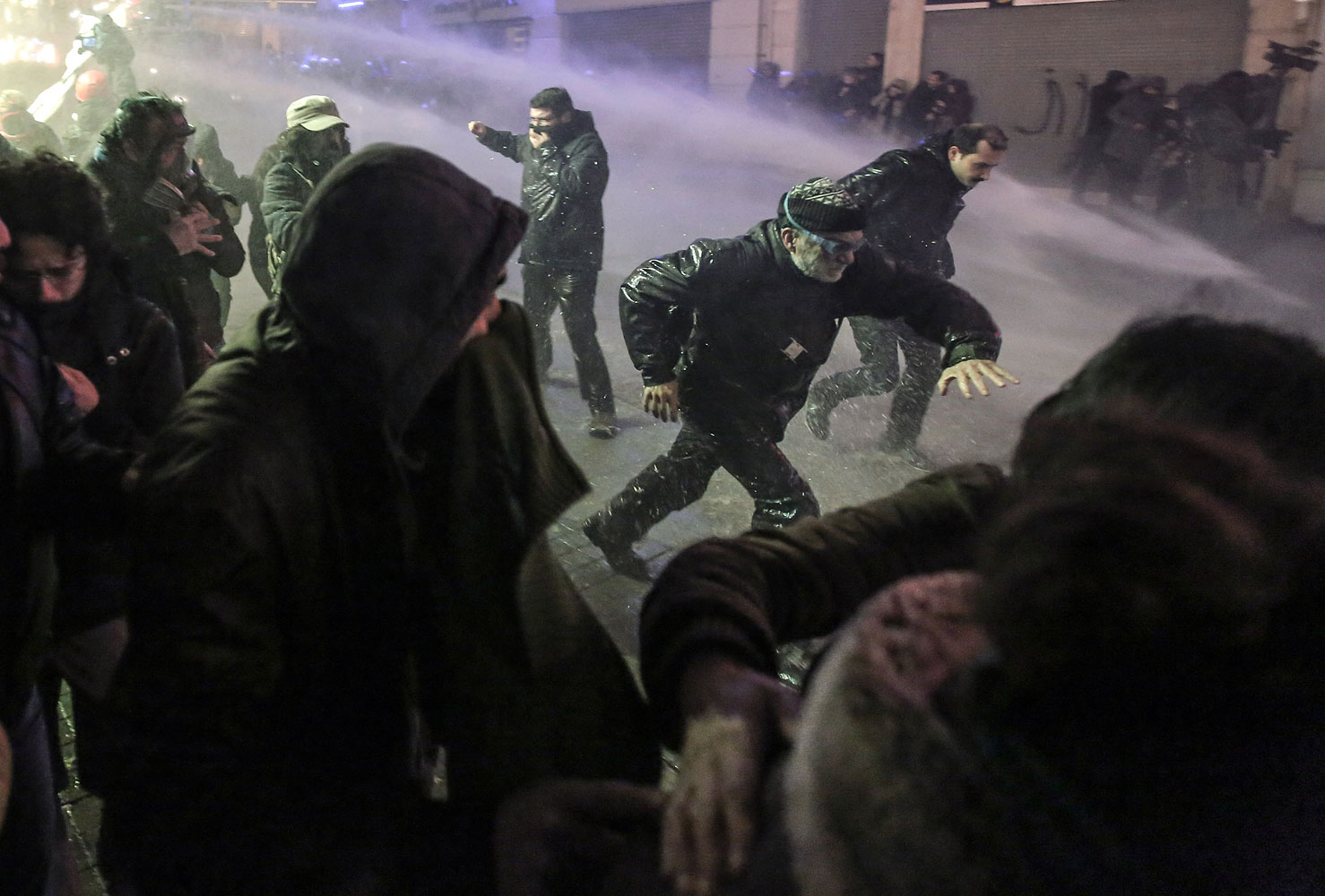 Riot police use water cannons to disperse people who protest the death of Berkin Elvan, a Turkish teenager who was in a coma since being hit in the head by a tear gas canister fired by police during the summer's anti-government protests, in Istanbul, March 11, 2014.