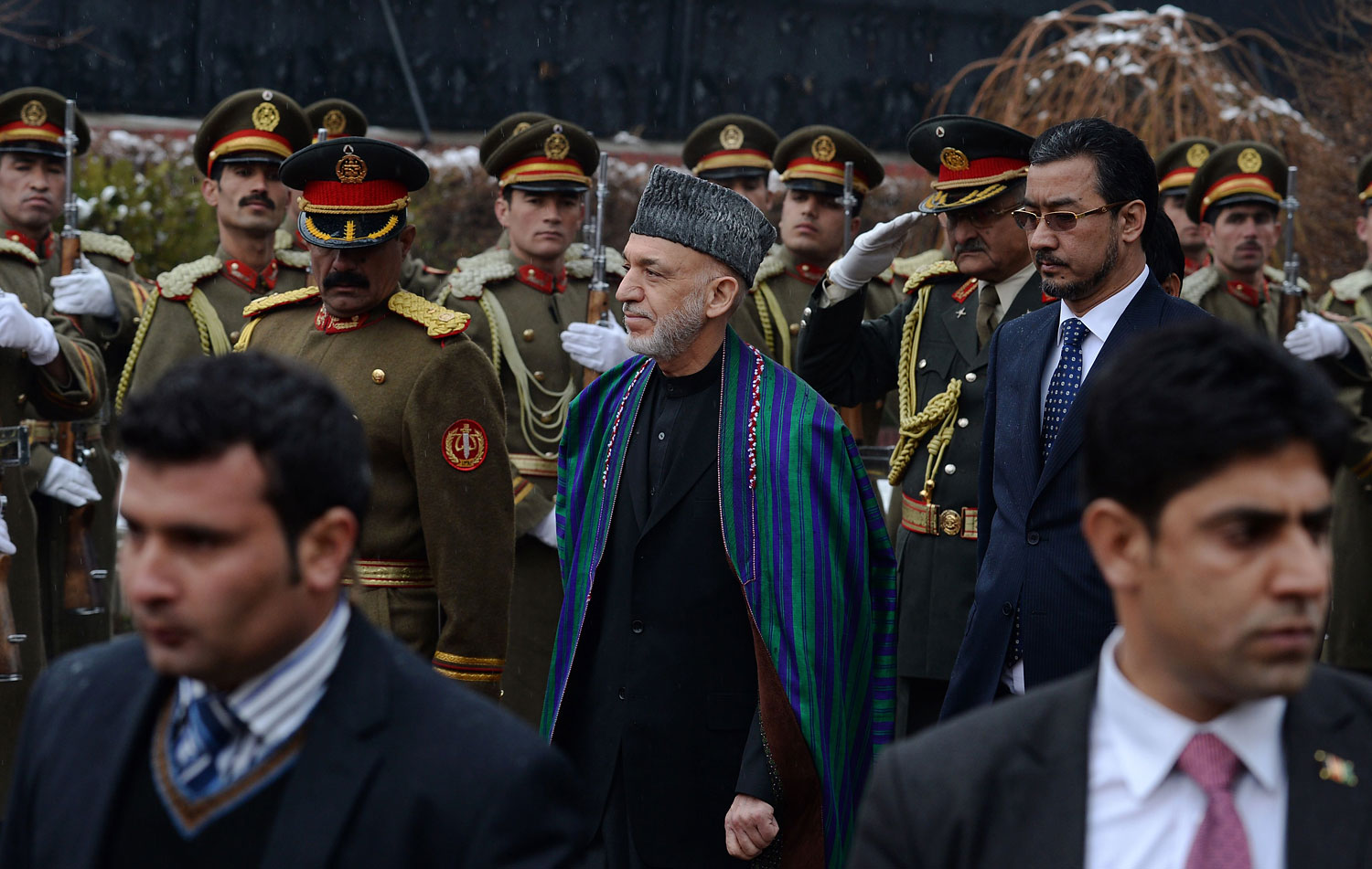 Afghan President Hamid Karzai, center, inspects a guard of honour as he arrives to deliver his final address in parliament in Kabul on March 15, 2014. (Wakil Kohsar—AFP/Getty Images)