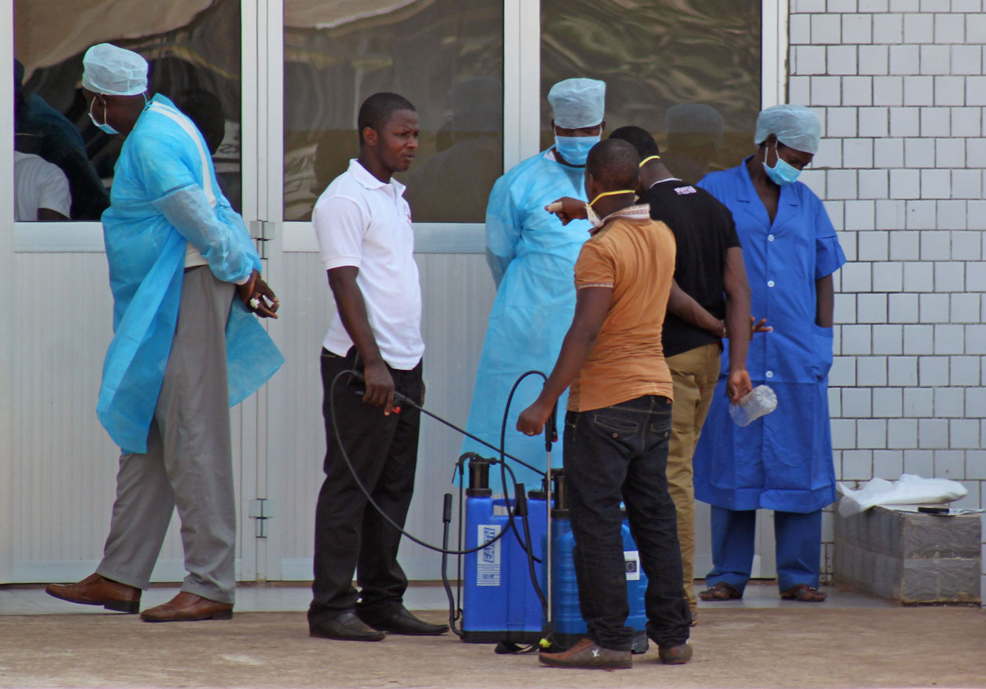 Medical personnel at the emergency entrance of a hospital receive suspected Ebola virus patients in Conakry, Guinea, March 29, 2014.