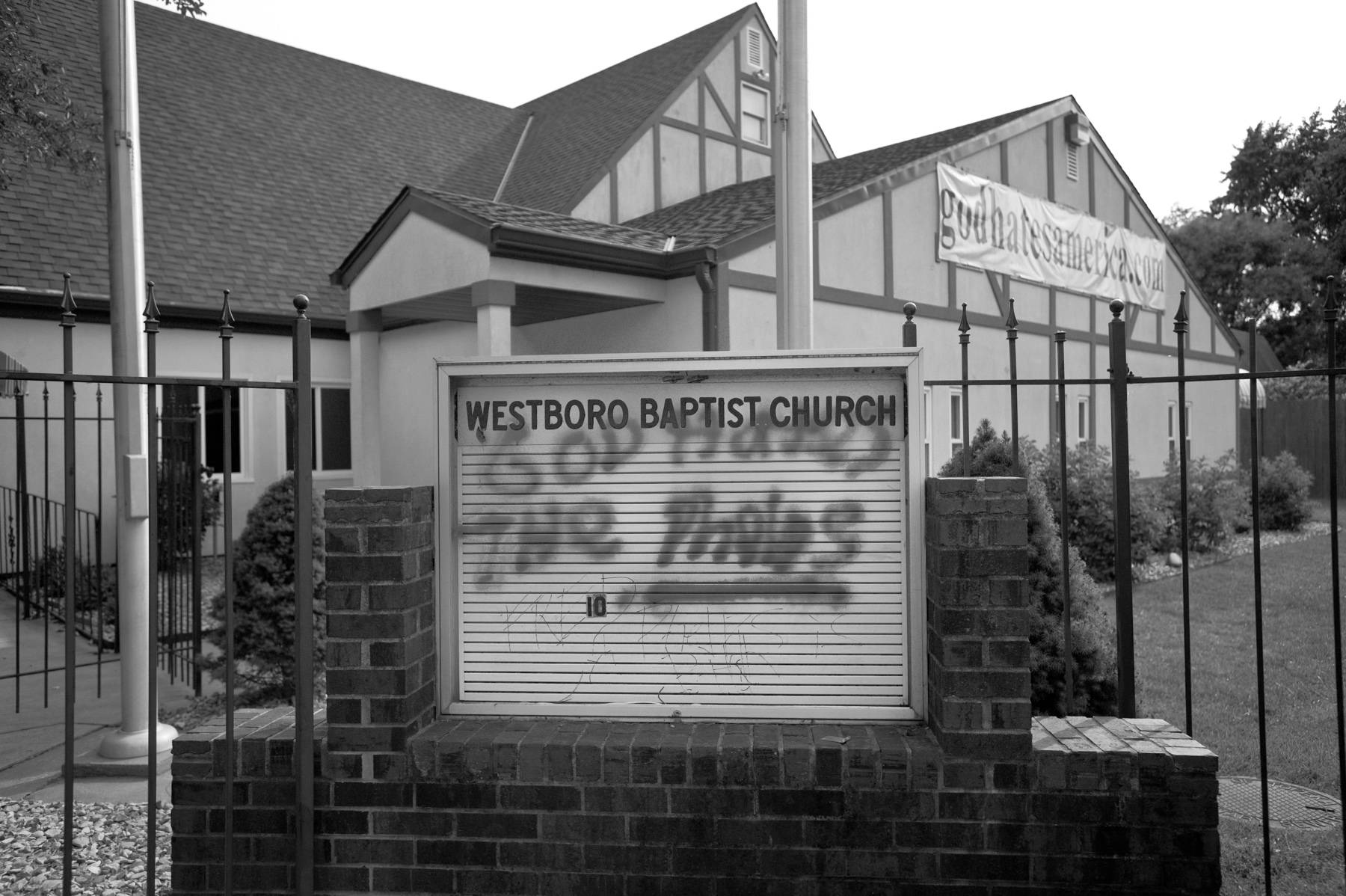 Graffiti defaces the sign of the Westboro Baptist Church.