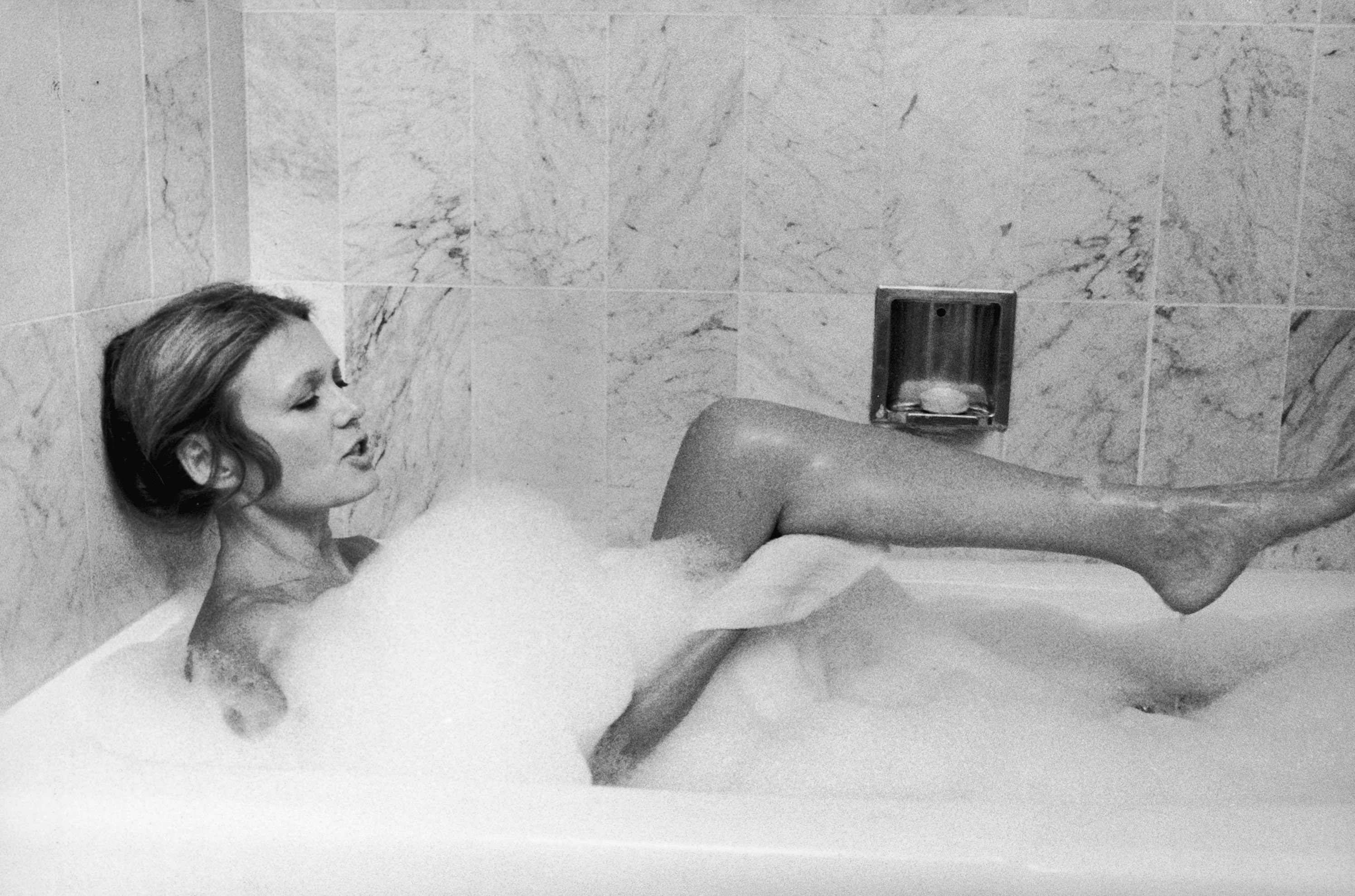 Feminist journalist and author Gloria Steinem baring one leg as she relaxes in a luxurious bubble bath at home. (Marianne Barcellona—Time &amp; Life Pictures/Getty Image)