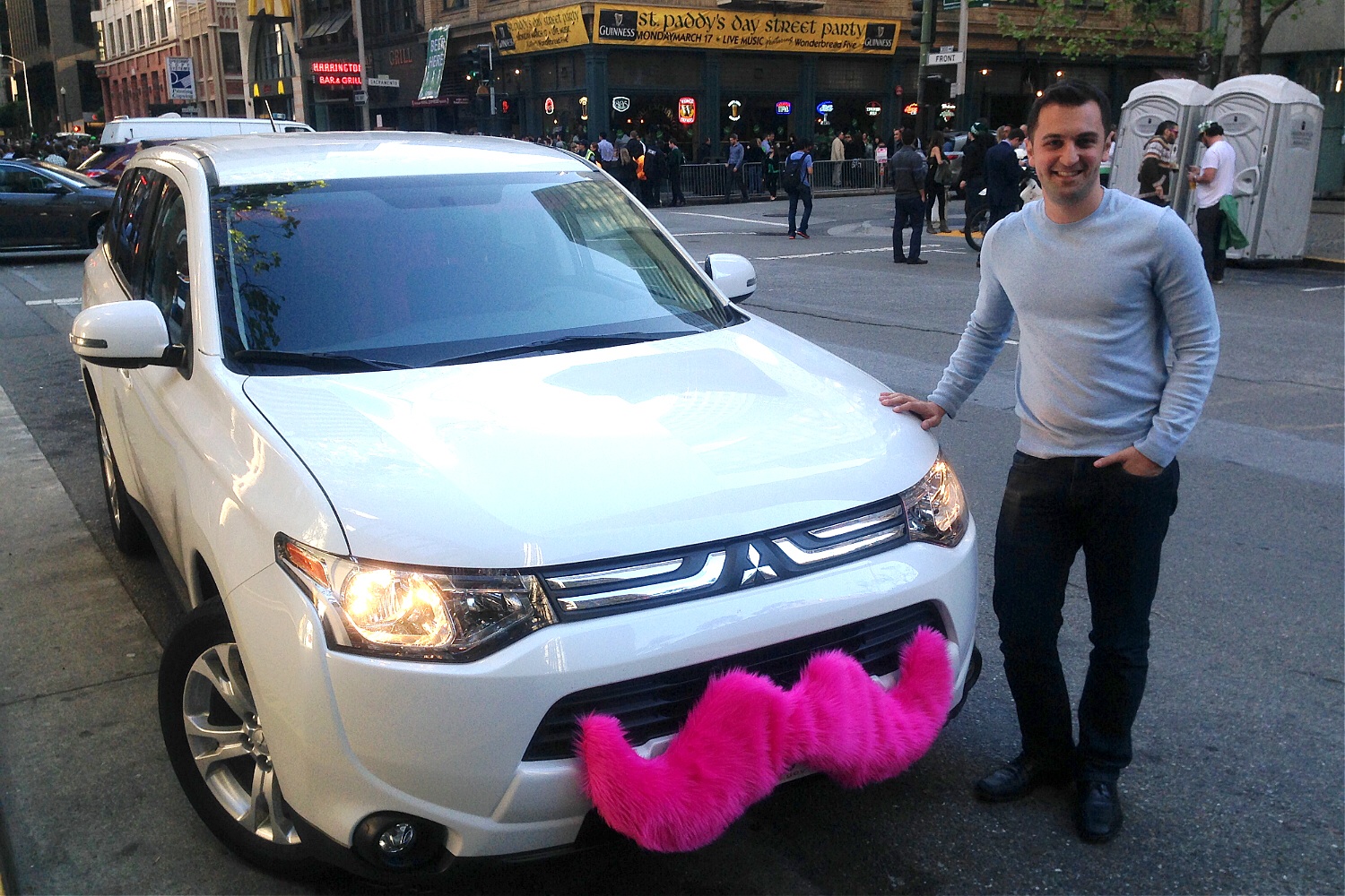 Lyft CEO John Zimmer poses with his ride in San Francisco on March 17, 2014