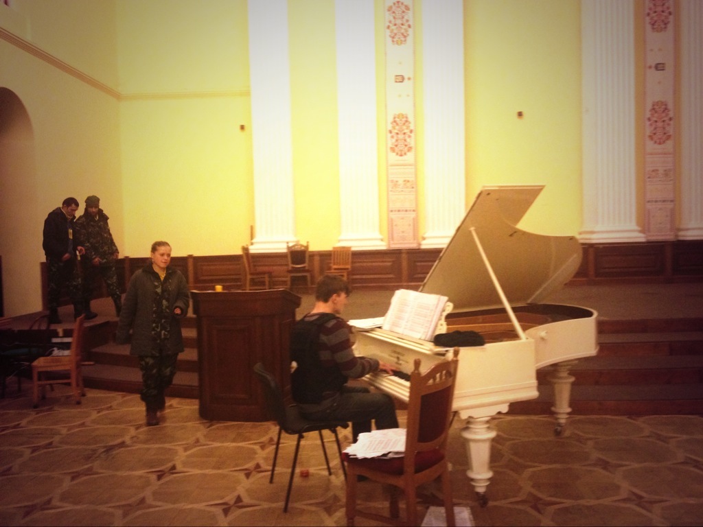 An activist wearing a bulletproof vest plays piano at Kiev's city hall, March 6, 2014.