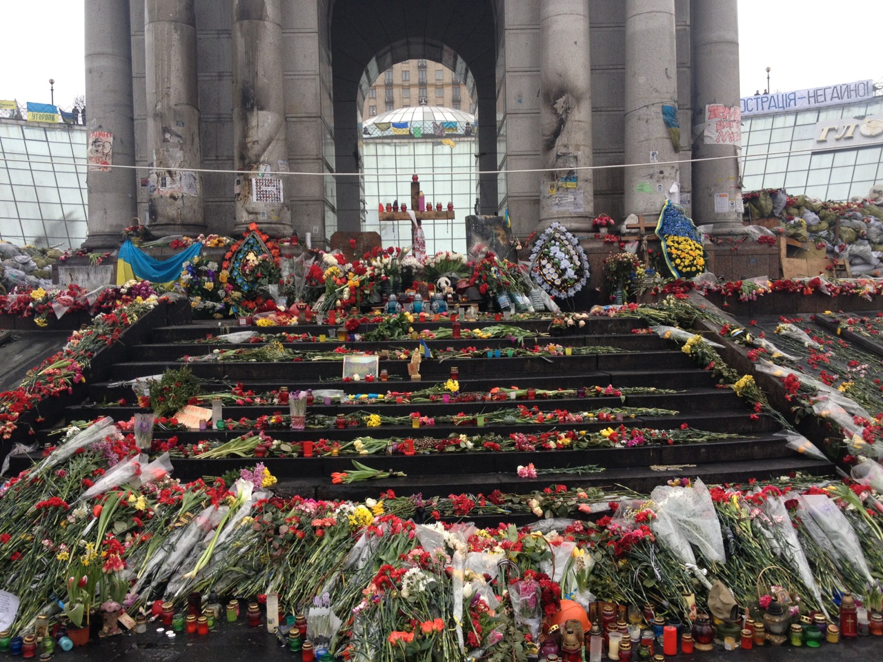 Flowers memorialize the dead at the square's independence monument. March 6, 2014.