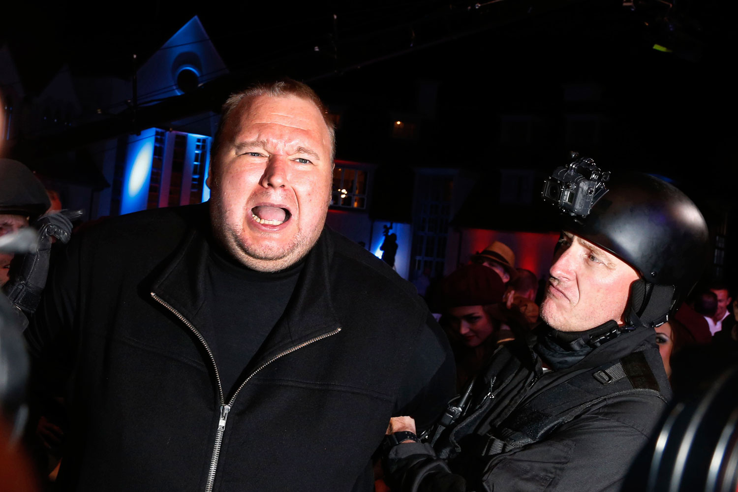 An actor in police costume mock-arrests Megaupload founder Kim Dotcom, left, as he launches his new file sharing site "Mega" in Auckland Jan. 20, 2013. (Nigel Marple—Reuters)