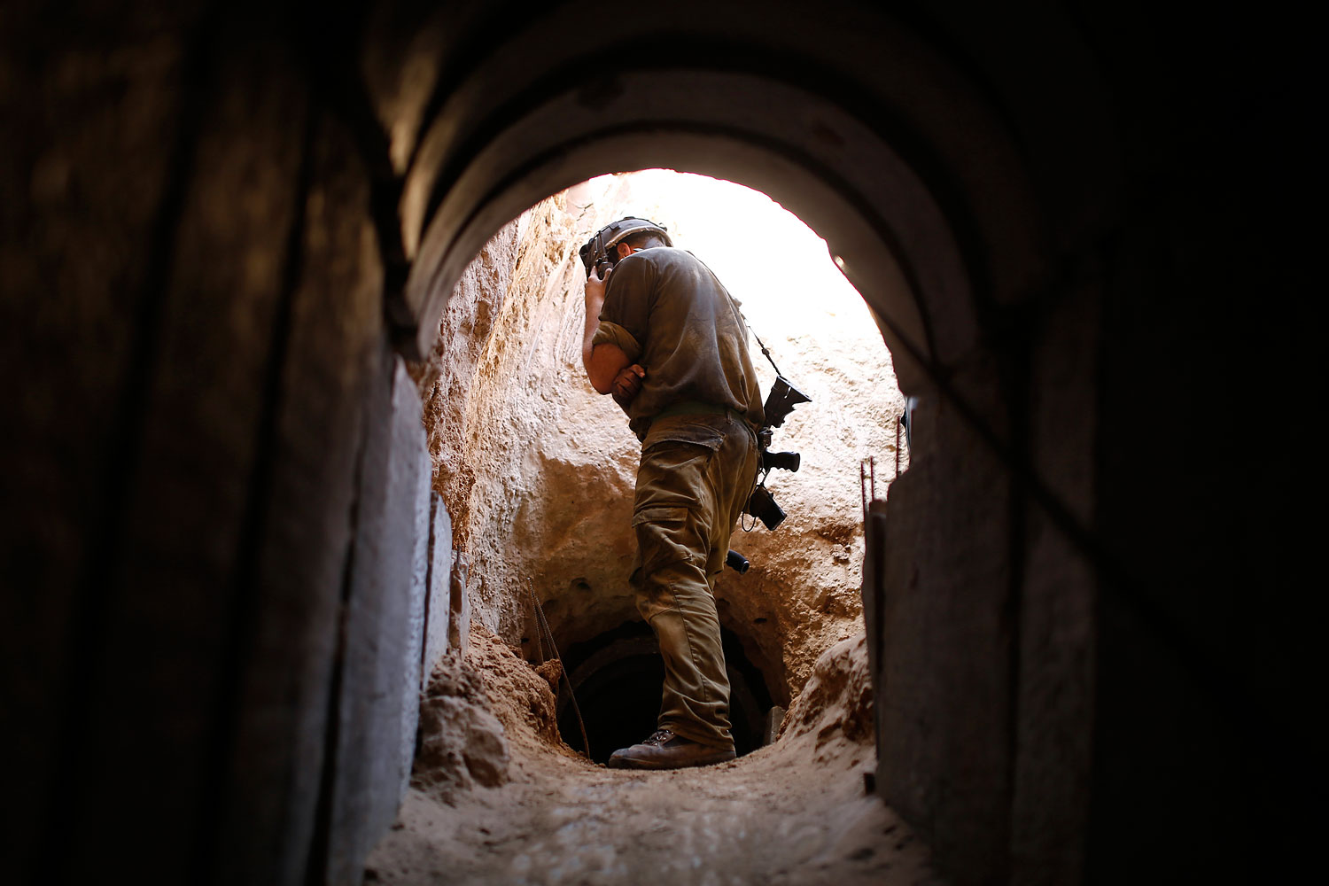 An Israeli soldier looks at a tunnel exposed by the Israeli military near Kibbutz Ein Hashlosha, just outside the southern Gaza Strip, Oct. 13, 2013. (Amir Cohen—Reuters)