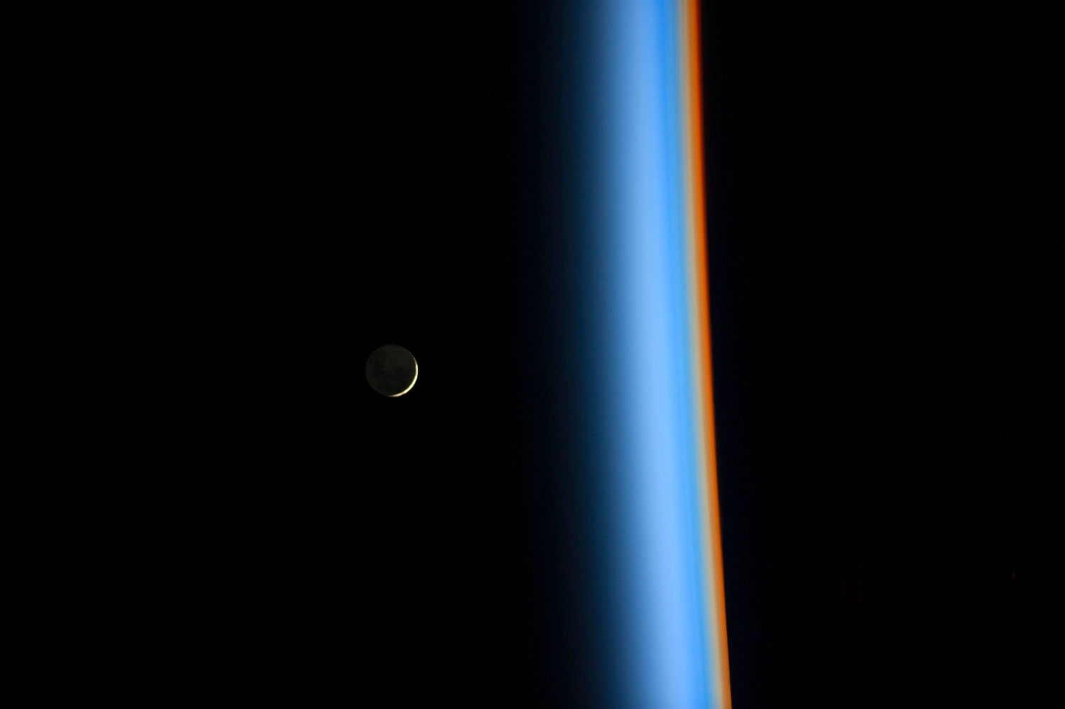 A crescent moon rises over the cusp of the Earth's atmosphere in this picture by Japan Aerospace Exploration Agency astronaut Koichi Wakata onboard the International Space Station on Feb. 1, 2014. 
                              Distinct colors are visible because the dominant gases and particles in each layer of the atmosphere act as prisms.