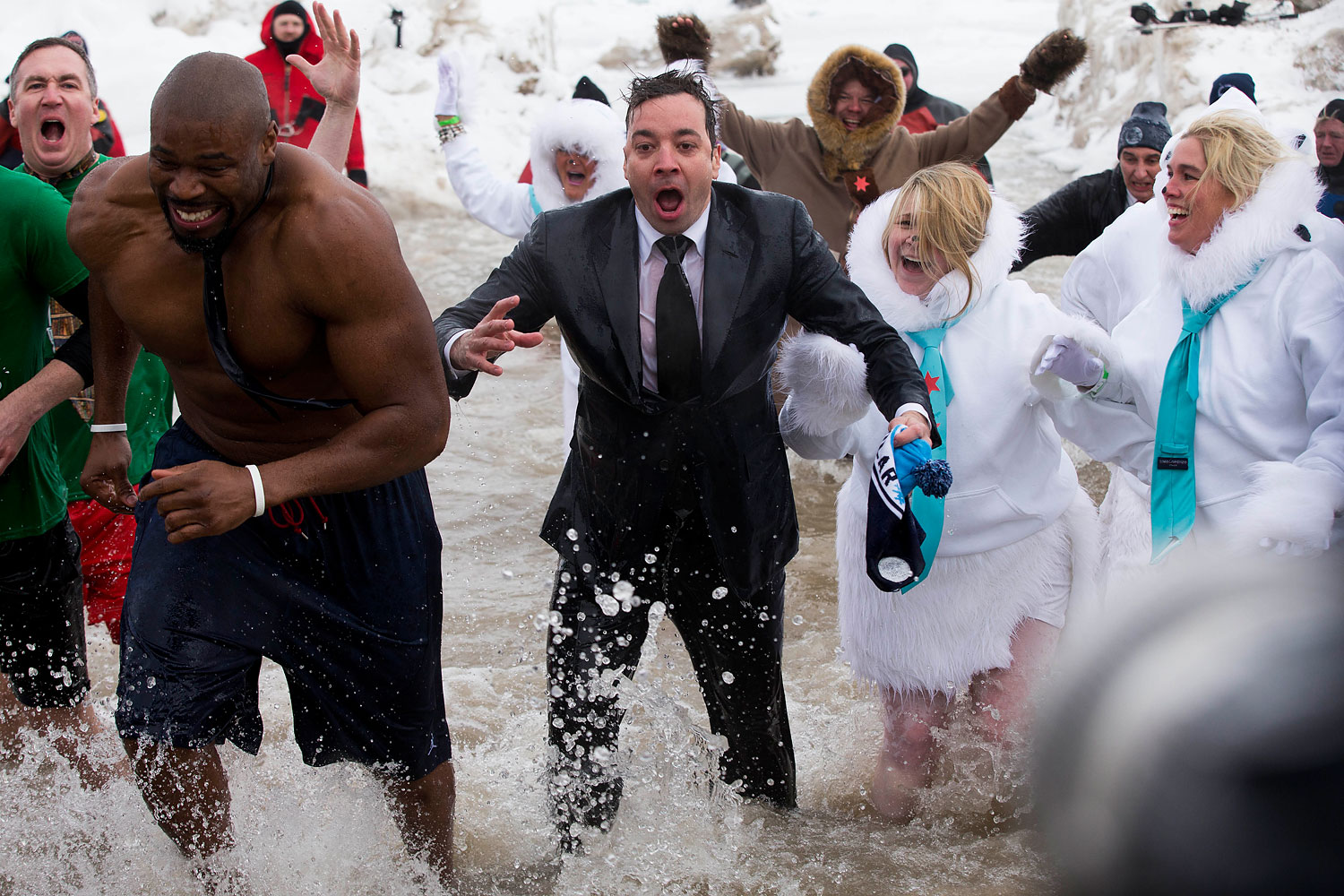 "The Tonight Show" host Jimmy Fallon, center, exits the water during the Chicago Polar Plunge, Sunday, March 2, 2014, in Chicago. Fallon joined Chicago Mayor Rahm Emanuel in the event.