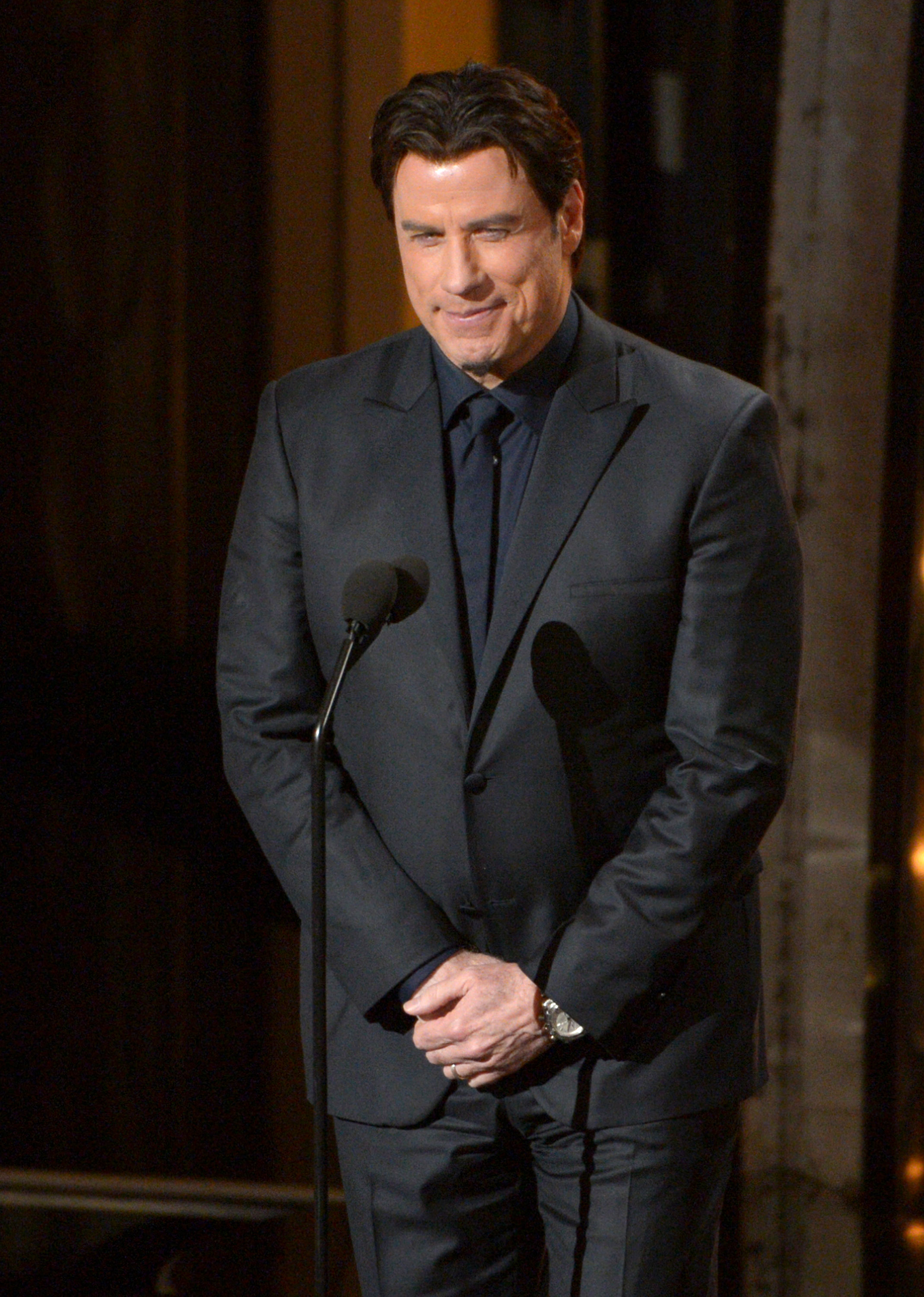 Presenter John Travolta speaks during the Oscars at the Dolby Theatre on Sunday, March 2, 2014, in Los Angeles.