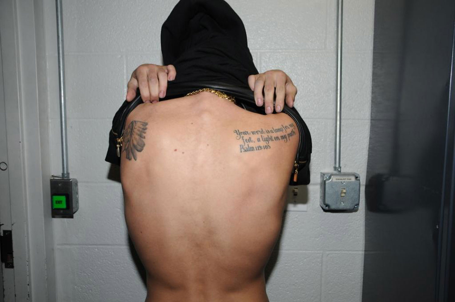 In this handout photo provided by the Miami Beach Police Department and released on March 4, 2014, singer Justin Bieber displays his tattoos for police documentation while in custody on January 23, 2014 in Miami Beach, Florida. (Handout—Getty Images)