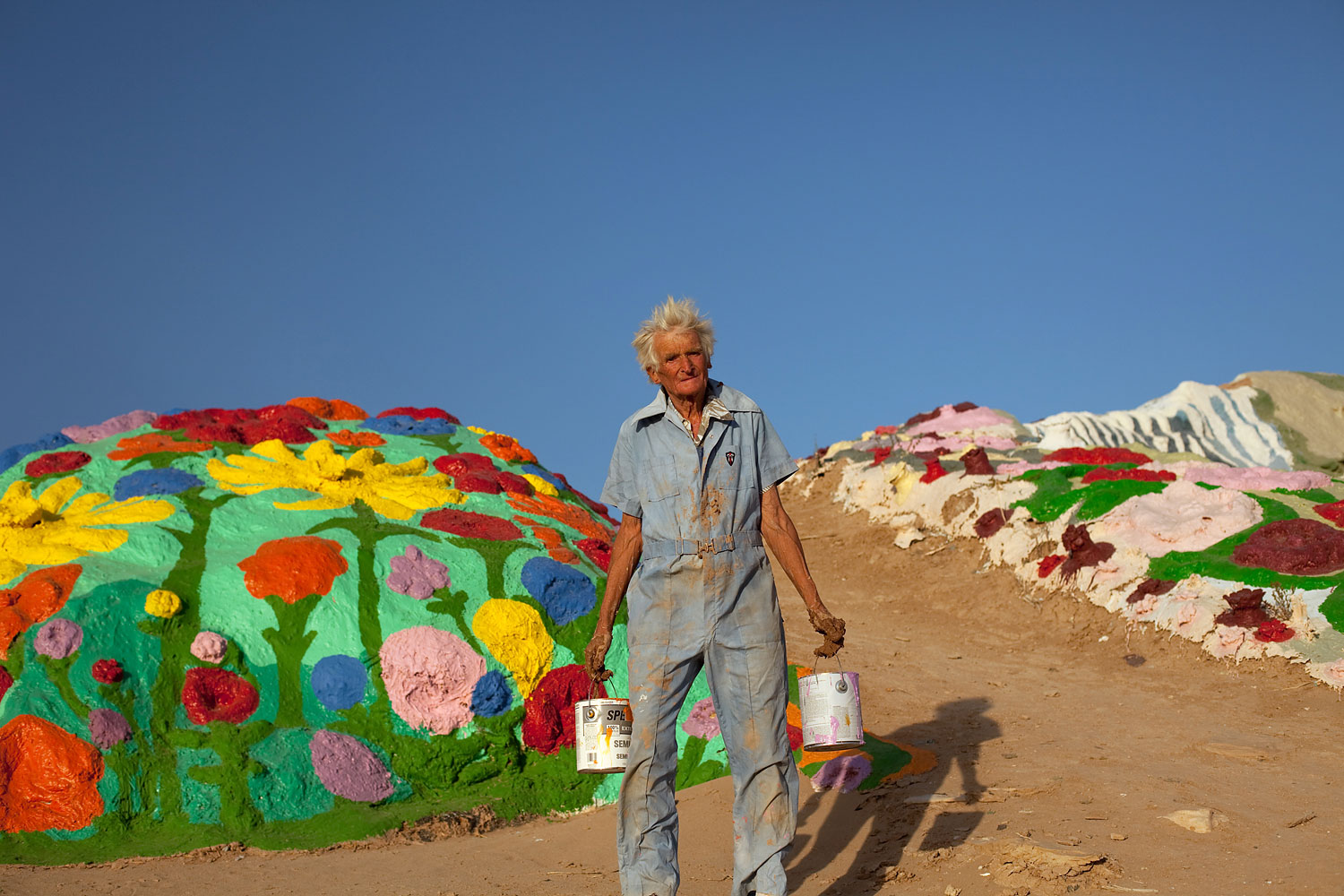Knight paints a peripheral mound covered in flowers, one of his common themes.