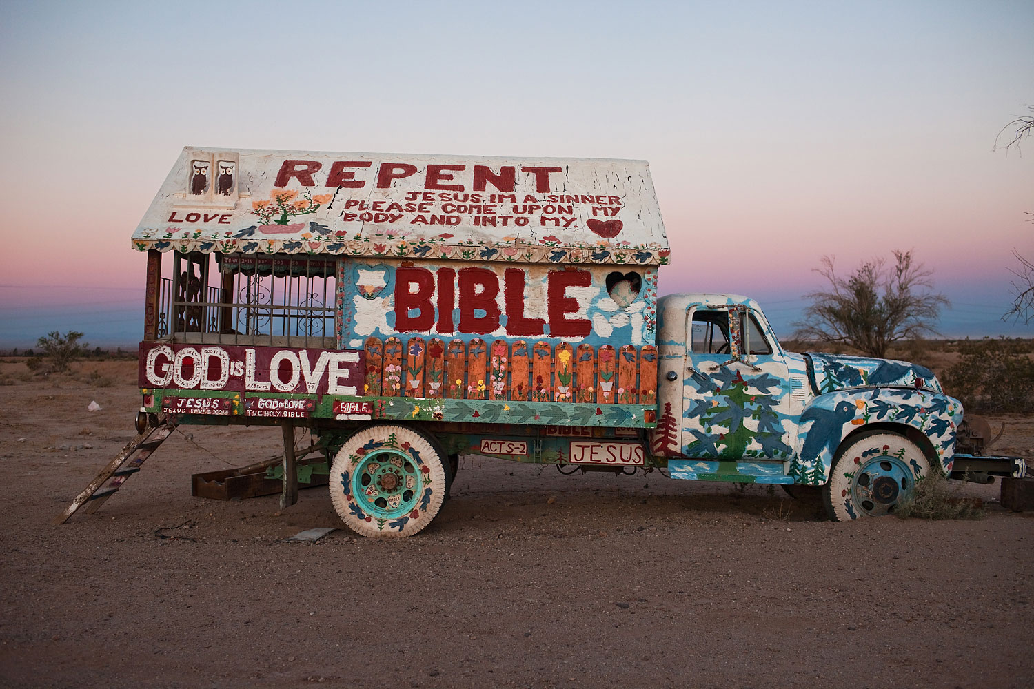 One of Knight's many art cars covered in scripture. He used to drive them in parades in the valley.