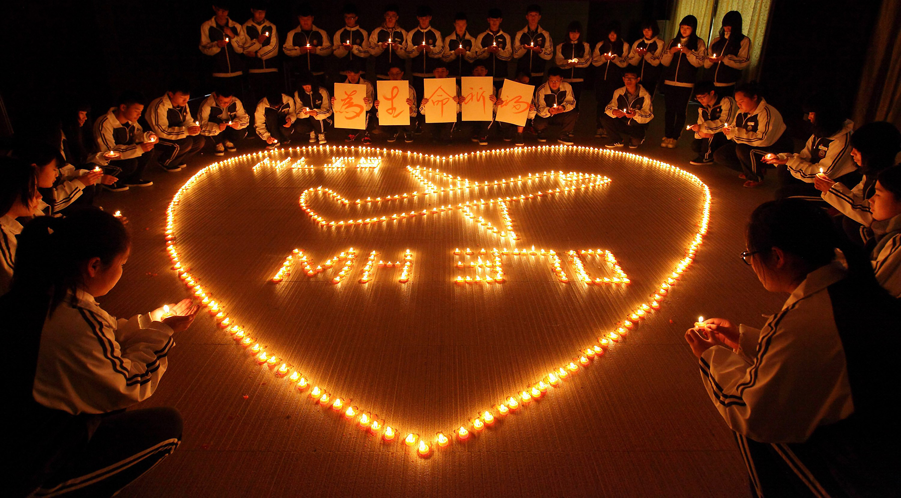 Students from an international school in the eastern Chinese city of Zhuji hold a candlelight vigil for the passengers on the missing Malaysia Airlines plane on March 10, 2014 (ChinaFotoPress/Getty Images)