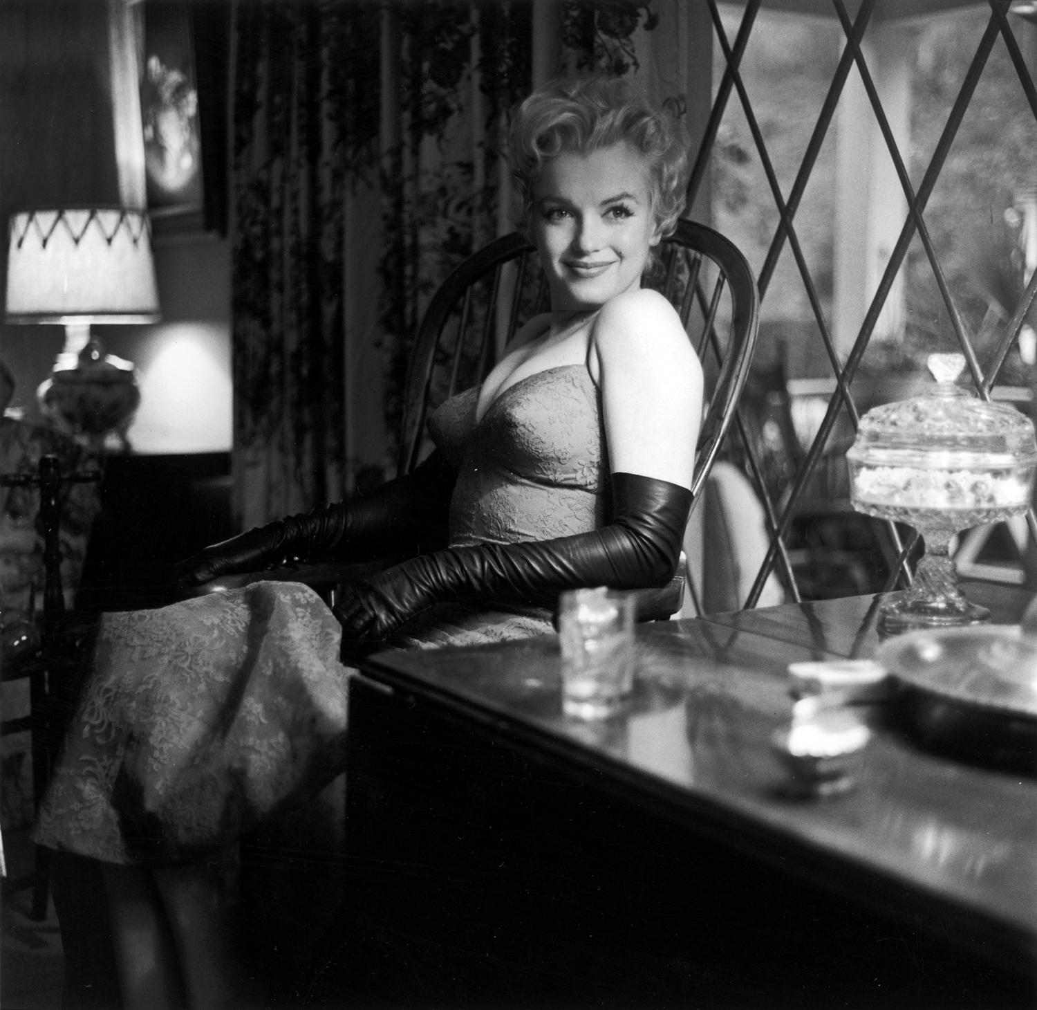 A 1955 image of Monroe posing by a window.