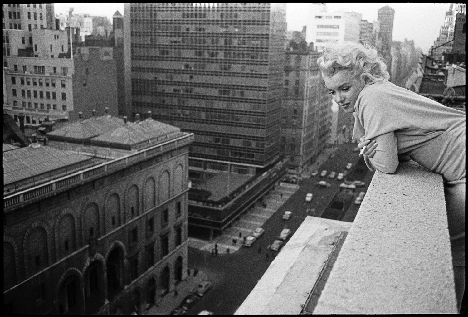Monroe leans over the balcony of the Ambassador Hotel in March 1955 in New York City.
