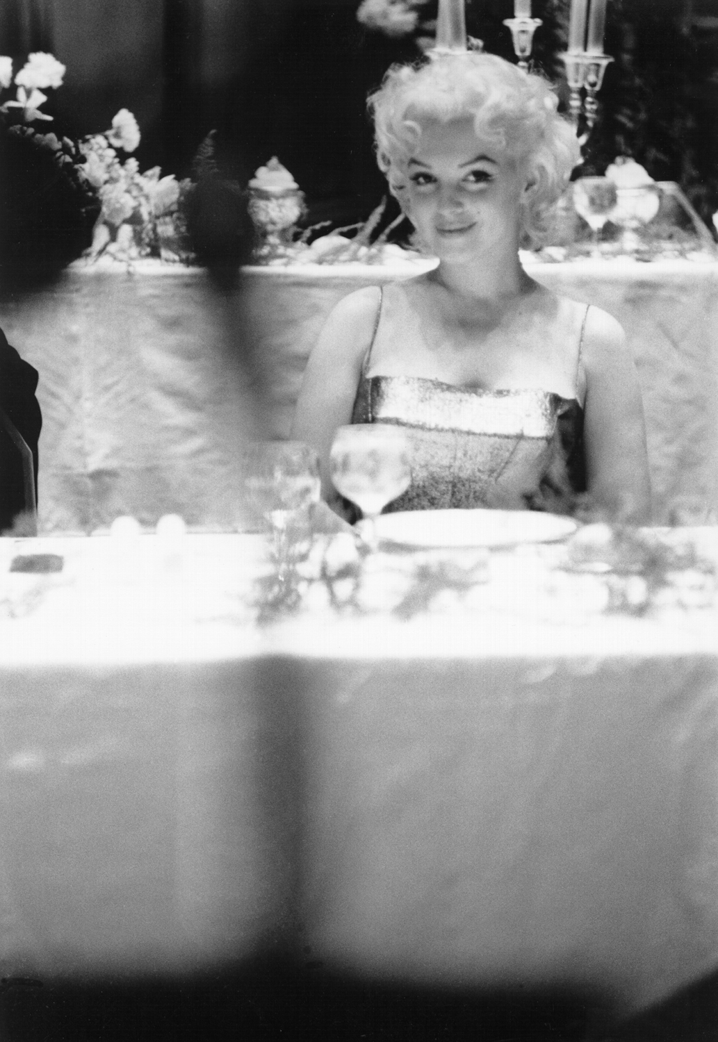 Monroe sits at a table in a restaurant in March 1955 in New York City.