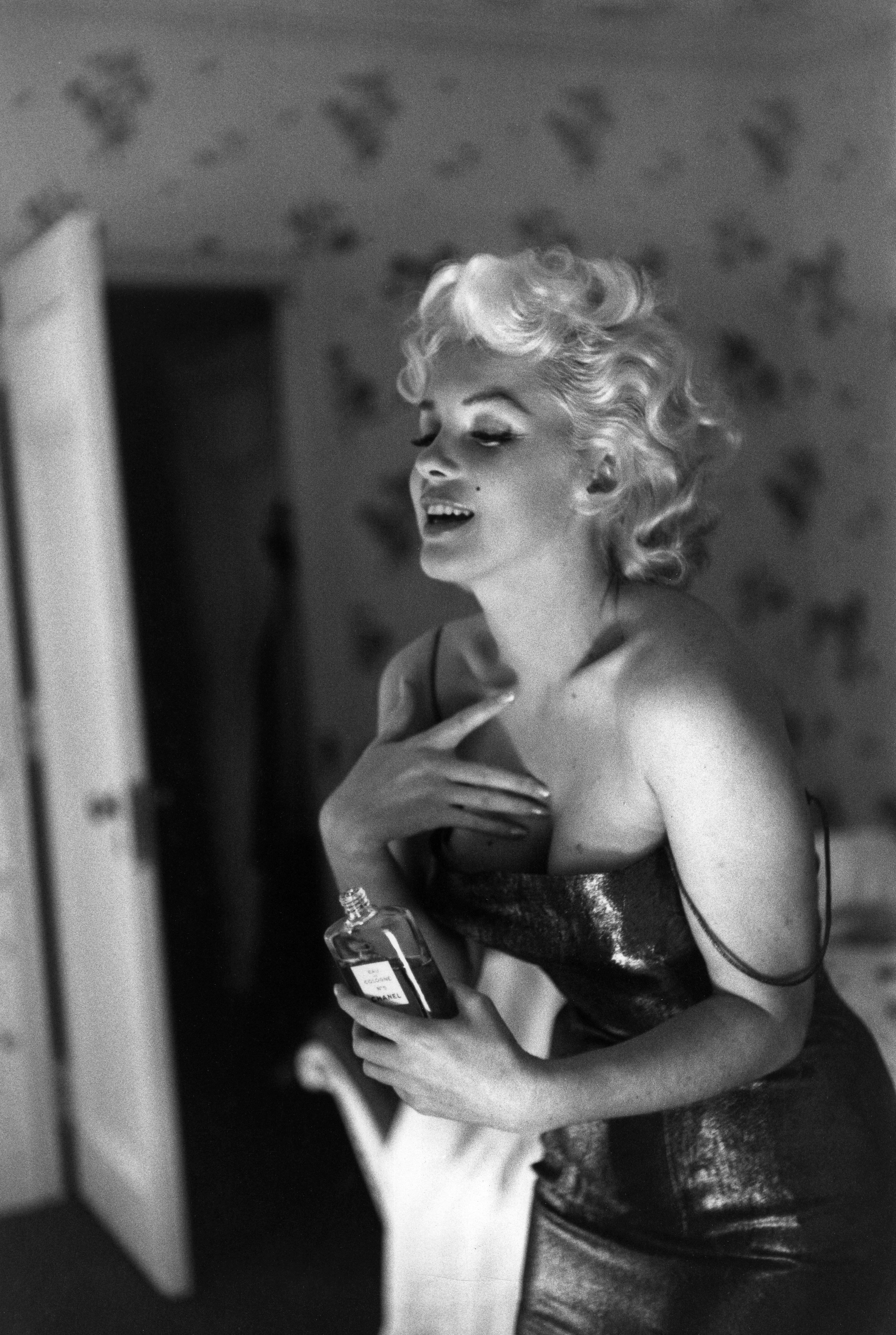 Monroe dabs on some of Coco Chanel's famous perfume while getting ready to go see Cat on a Hot Tin Roof. In a famous quote, when asked what she wore to bed, the screen siren answered,  Chanel No. 5, of course.