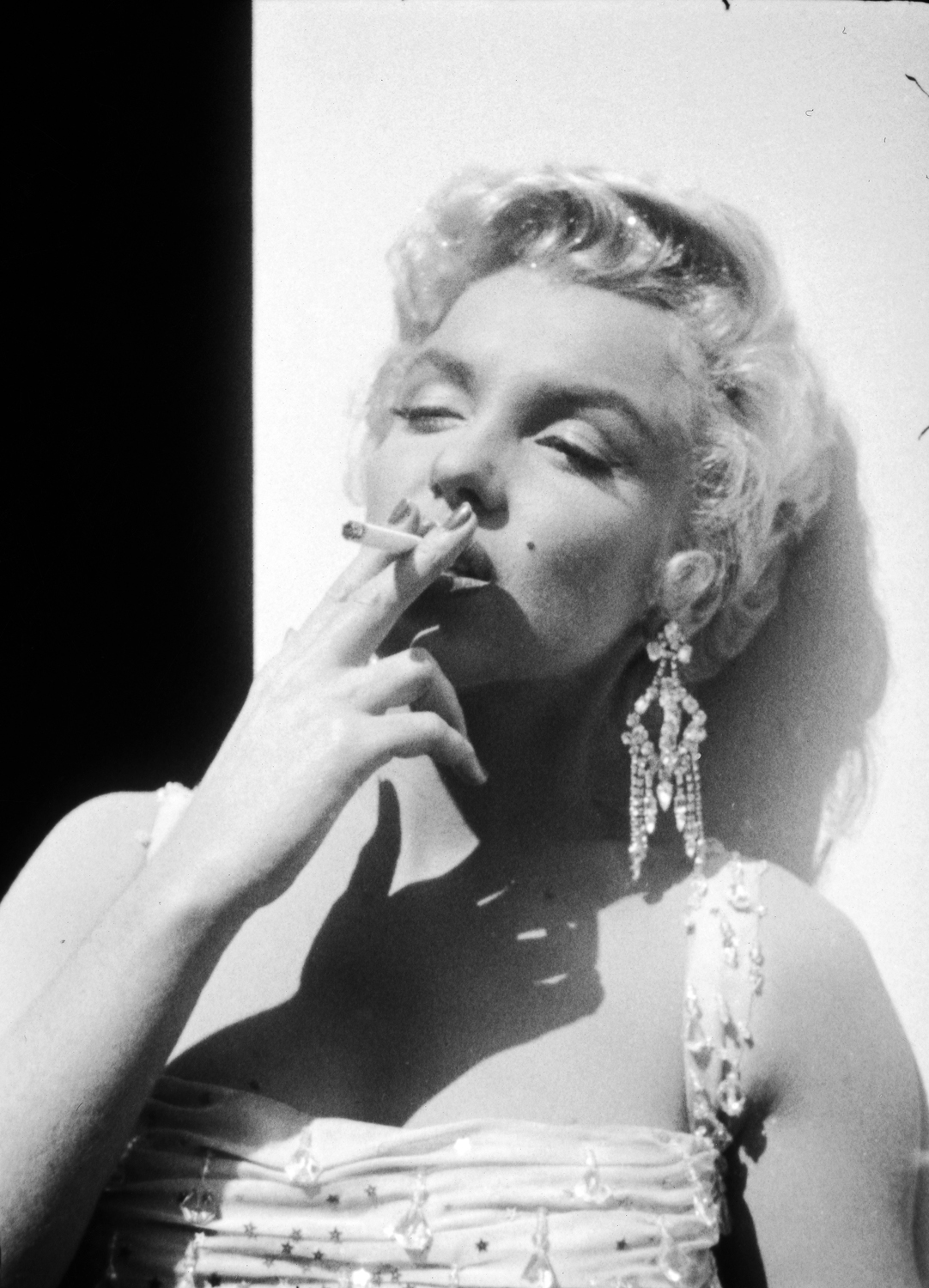 Monroe smokes on the set at the 20th Century Fox studios in 1954.